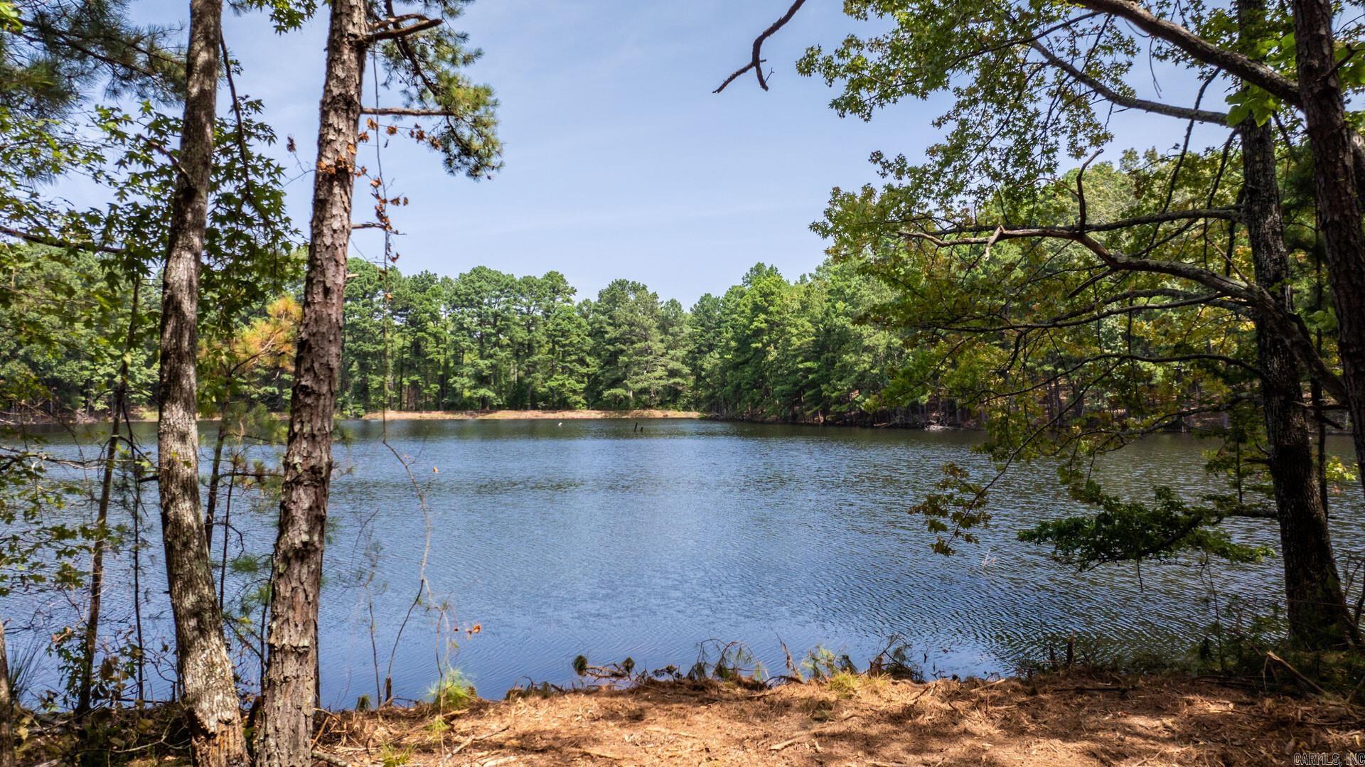 Koban Lake, a clear 12-acre private lake, is the centerpiece of this 156-acre property in West Little Rock, now available for the first time since the Colonel Glenn and I-430 area became one of the largest areas for commerce in the city. Perfect for fishing and recreation, the lake is part of the 108 acres on the south side of Lawson Road. The north side includes 48 acres with a ridge, offering a stunning site for building. You can choose to build a lakefront property by Koban Lake or on the ridge for elevated views. The land features mature timber and McHenry Creek, providing a natural habitat for wildlife, ensuring both privacy and abundant outdoor opportunities. Utilities are available, making the property ready for development. Conveniently located 2 miles from the I-430 and Colonel Glenn intersection, 10 miles from Downtown Little Rock, and 5 miles from Chenal Parkway, this property combines seclusion with accessibility. This is a rare opportunity to own versatile land in a prime location.