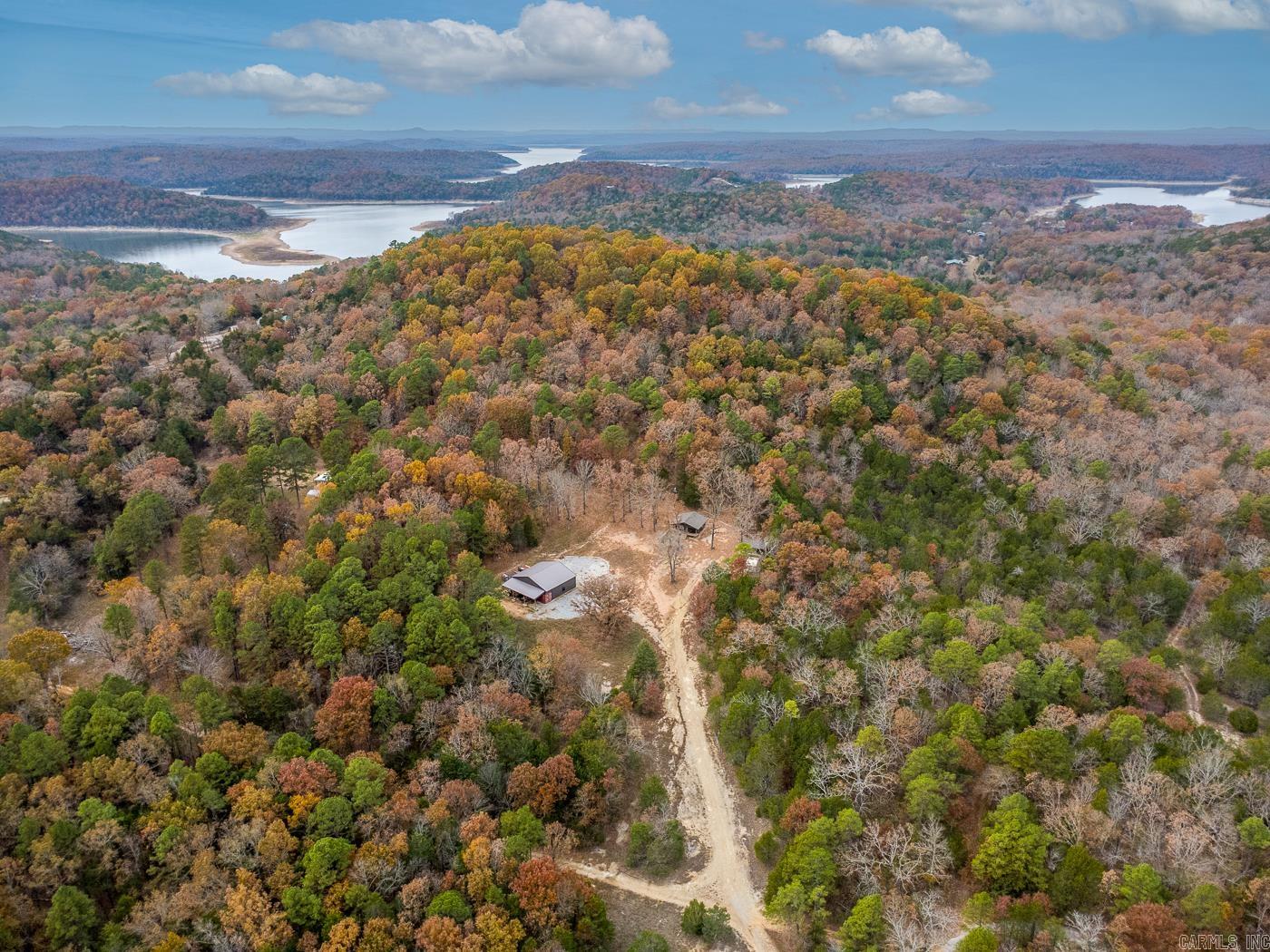 Welcome to Market 421 Tail Star Trail of Elizabeth, AR within Fulton County. Outdoor & nature enthusiasts, this one's for you. This Norfork Lake area property w/ 2.9 +/- acres and boat slip has it all. Situated on the house lot is a 2022 built cozy cabin wrapped in Hardie board, topped w/ architectural shingles and accented by a covered front porch. The efficiency style interior features 576 sf of well laid out living space that includes a living/dining/kitchen area, utility room, bathroom w/ walk-in shower, and cedar lined walk-in closet. You'll love the hardwood floors, vinyl windows, and that it comes fully furnished. The 30x40 wired & floored shop w/ lean-to contains an attached 8x40 container, bunk room, and 2 overhead doors. Also on site is a 12x20 storage building, custom carport, firepit, private well, and septic. You're ready for a day on the lake spent fishing or just relaxing w/ a private boat slip that conveys. Conveniently located near Hwy 62/412 and just 30 miles to Mountain Home. Call today to tour and make this turnkey house & acreage your home or home away from home. *Additional 161 ± surveyed acres near the property are available to purchase separately.