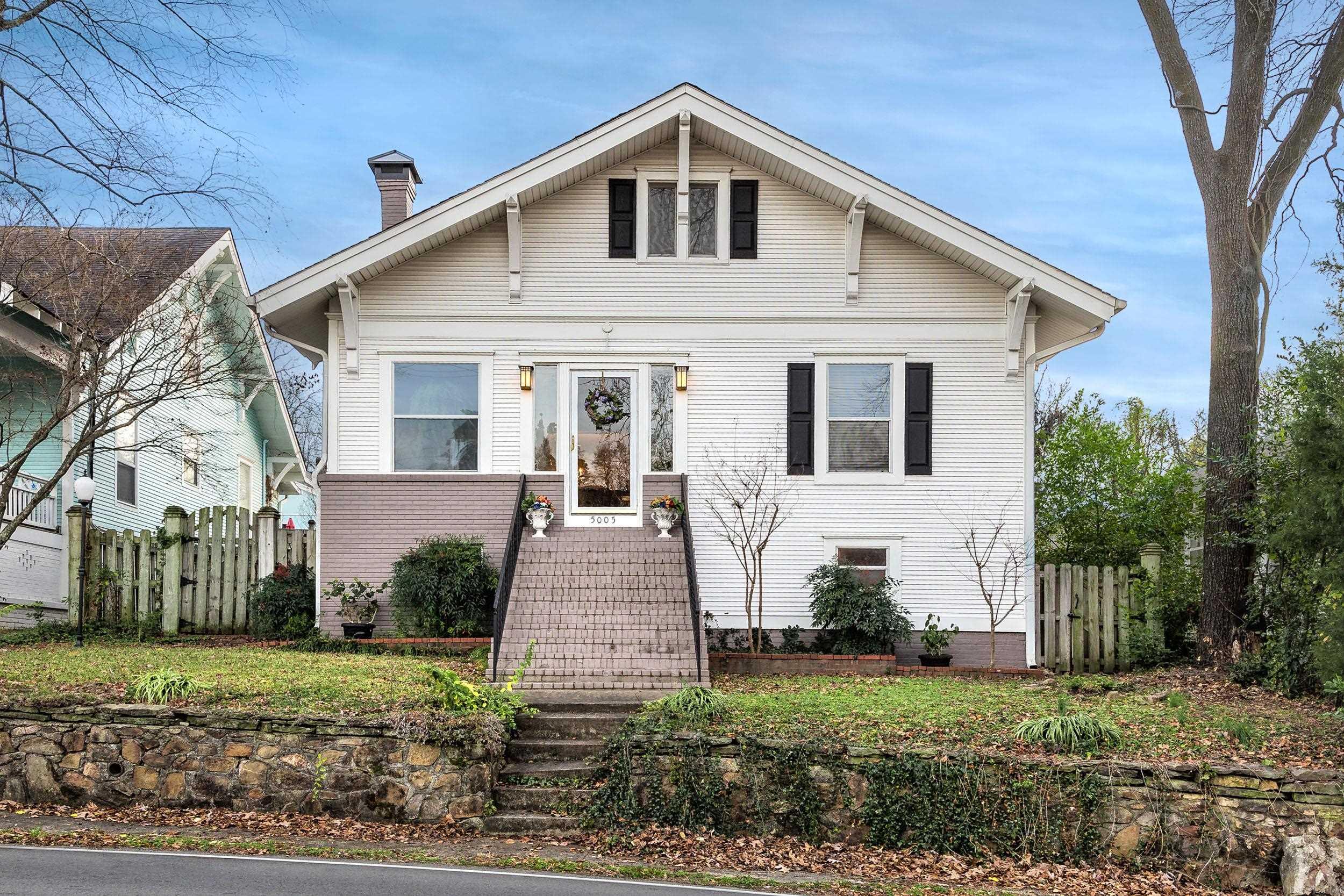 One of the oldest homes in Hillcrest built in 1913 and owned by one family since 1942.  Originally a one level home that was expanded and extensively renovated to a 2 story around 1999-2000.  Primary bedroom with a sitting area down and 2 bedrooms plus a bonus room upstairs.  Through the front entry is an enclosed sunroom that opens into the original living room with ventless gas log FP and dining room with hardwood floors and trim work.  Kitchen with ample cabinets opens into an eat-in area and a cozy den with 1/2 bath. Quaint patio and fenced backyard with a back alley carport and parking pad. Water heater is new. Furnace replaced in 2019