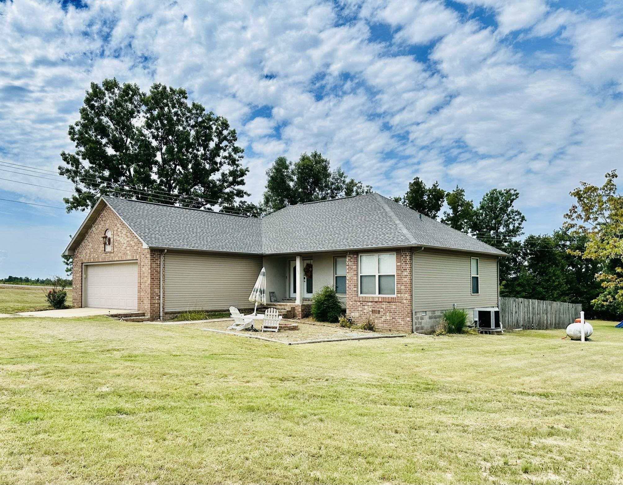 This 3 bedroom, 2 bath brick home is nestled on 3 acres outside the city limits of Viola, Arkansas. Located just a short drive away from the city of Mountain Home and the serene Norfork Lake, this property offers the perfect balance between convenience and seclusion. Surrounded by pastureland, this property provides ample space for outdoor activities and a peaceful ambiance. The property boasts a seasonal pond, adding to its natural beauty. As you enter this 1,898 square ft home, you'll be greeted by an abundance of natural light streaming through the big windows. The beautiful brick exterior adds to the home's classic charm and timeless appeal. A garage is available, providing convenient parking or storage space. Additionally, the property offers an RV hookup complete with a septic system and power, allowing for the accommodation of additional vehicles or guests. Viola, Arkansas offers a delightful small-town atmosphere while still providing easy access to the amenities and recreational opportunities available nearby. This home offers a harmonious blend of rural living and urban convenience. Listed for the great price of $199,900!
