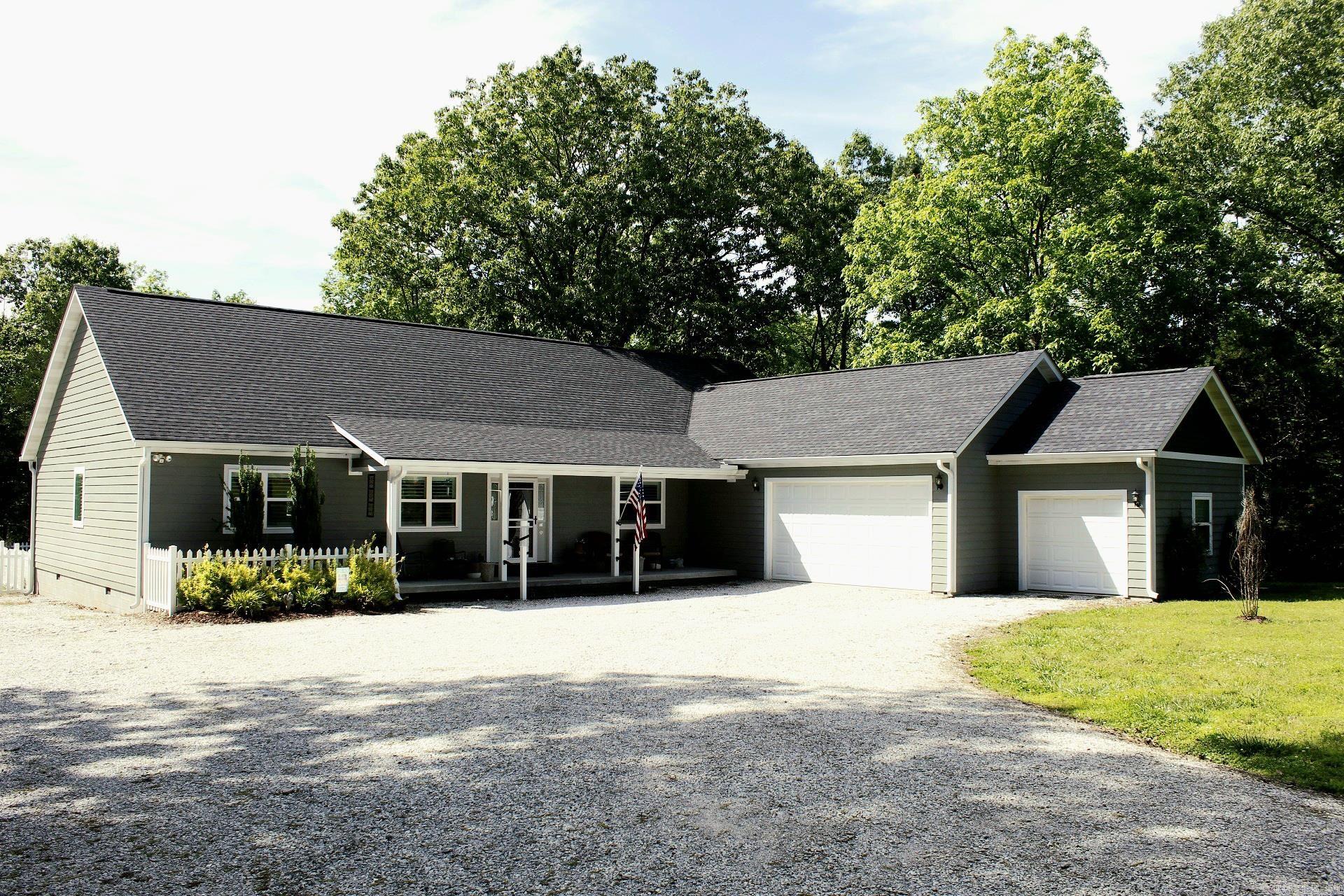 Discover the perfect blend of comfort and convenience with this lovely 4 bedroom, 2 1/2 bath home, offering 2580 sq. ft of well-maintained living space on a spacious 3.2 acre corner lot.  Home offers open concept to allow for family/friend gatherings. Primary bedroom and bath offer walk in shower, soaking tub, 2 walk-in closets, 2nd full bath for the 3 guest bedrooms, plus a half bath also for guest. Backyard is fenced, newer large deck with a 3-season sitting area, 2 car garage, plus an extra 3rd car attached garage, presently used as a studio, whole house generator, detached shop and this is just some of the amenities you will find with this great property.