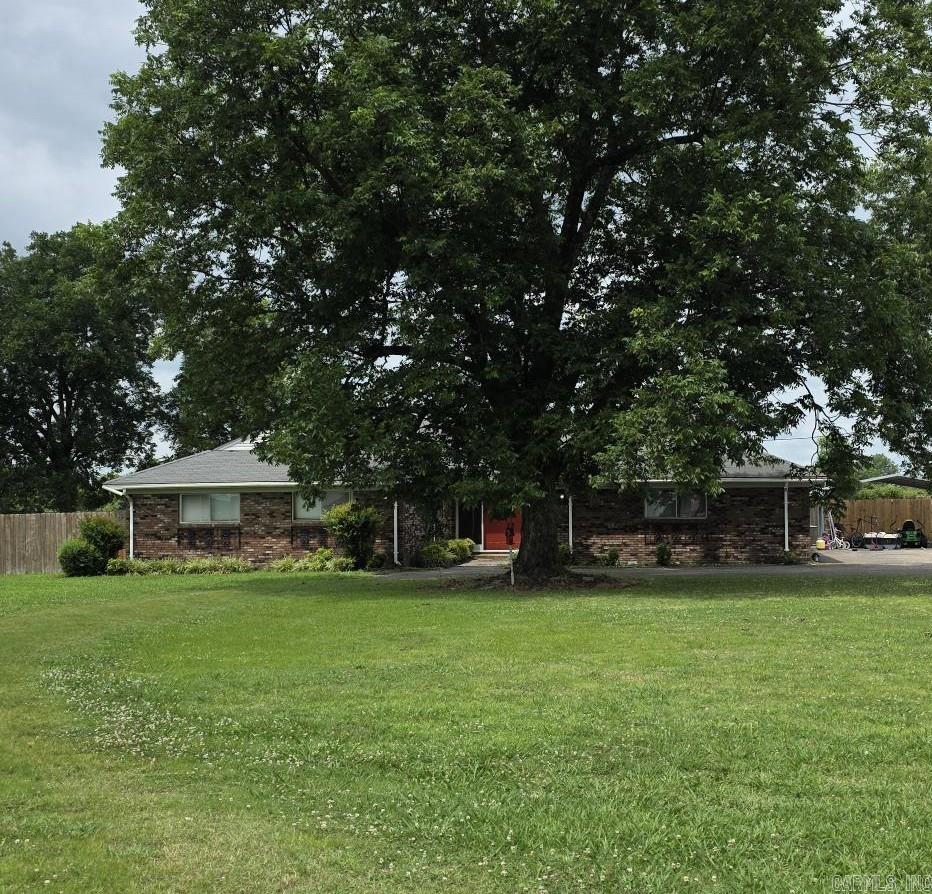 Country Living in City Limits!   This wonderful home is perfect for entertaining.  Enjoy and relax in the beautiful inground swimming pool.   This home offers 3 bedrooms and 2-1/2 bathrooms.    There is a multi-purpose bonus room on the back which can be a sunroom, mancave, office, game room, etc.    This room is currently being used as bedroom.   The room layout for this home provides optional choices for usage.   The kitchen is open to a large living area ideal for entertaining, while another room that features a fireplace, can be cozy den or living room.  Notice there is a breakfast room and dining room.   You will love the built in cabinets and shelving.  It is surprising to walk in the backyard and see that most of the acreage is fenced.  (Privacy!!)   Call and make an appointment to see how these options will work for you.