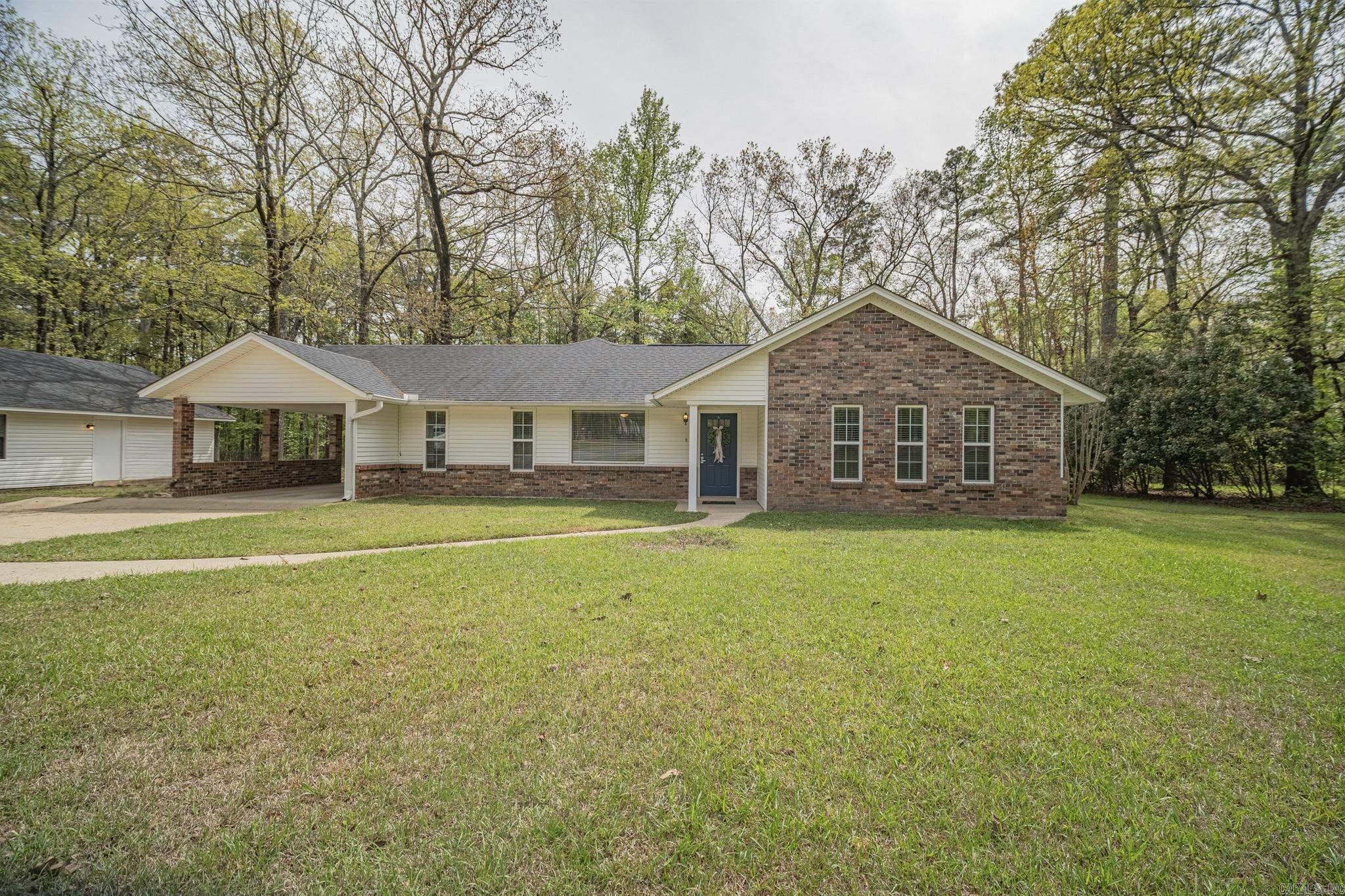 This 4-bedroom, 3.5-bath home sits on 1.5 acres on a tree-lined street inside the city limits, offering a combination of space and convenience that’s becoming harder to find. Mature trees provide a beautiful setting, and the detached shop includes a garage, a separate finished room, and its own half bath, making it a great fit for a workshop, home office, hobbies, or extra storage. Inside, you’ll find a comfortable layout with luxury vinyl flooring and tile, an updated primary bathroom, and updated kitchen appliances. The kitchen opens to the living and dining areas, creating an easy flow for everyday living and entertaining. A covered carport, a roof replaced within the last five years, and the spacious yard complete the property. If you’ve been looking for acreage in town with a detached shop and recent updates, you’ll want to take a look at this one.