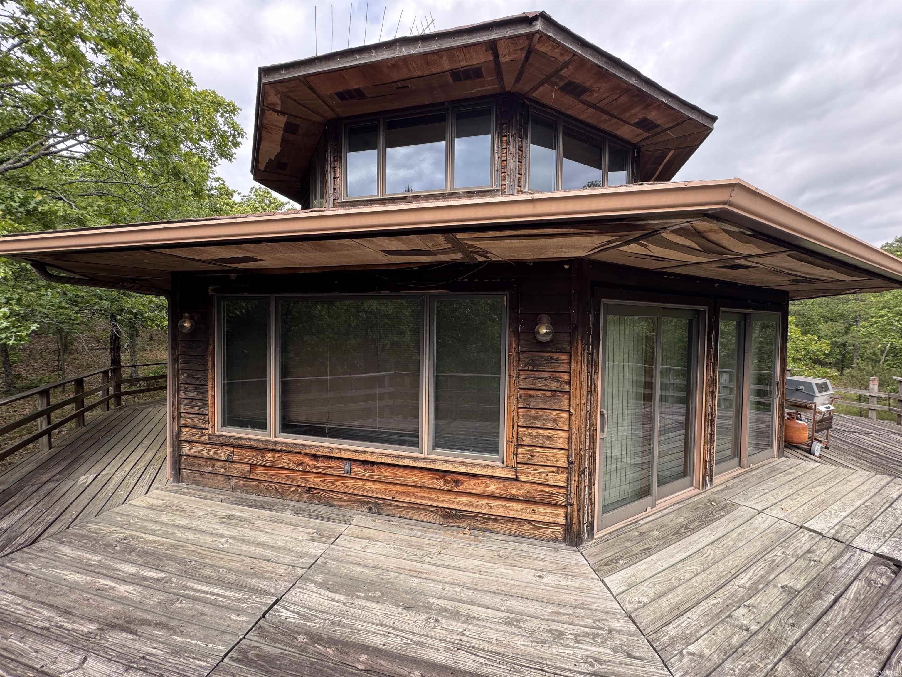 Once in a lifetime opportunity to own this one owner custom built octagon cedar home on 8 acres toward the end of a peaceful rural dead end road. The property is wooded and private. Remove some trees and get million dollar views of the Ouachita Mountains and Lake Maumelle. Get an idea from the many windows throughout the home and up the spiral staircase to the "Eagle's Nest" where a full bath and walk-in closet resides. Not many opportunities to own such a property close to Little Rock. Turkey, Deer, Bear and countless species of migratory and other native species of plants and animals call this area home also. A seasonal creek is on the property along with mature oak and other trees. The house is super clean. Could use some TLC, but worth it! House is in an estate. Agents see remarks.
