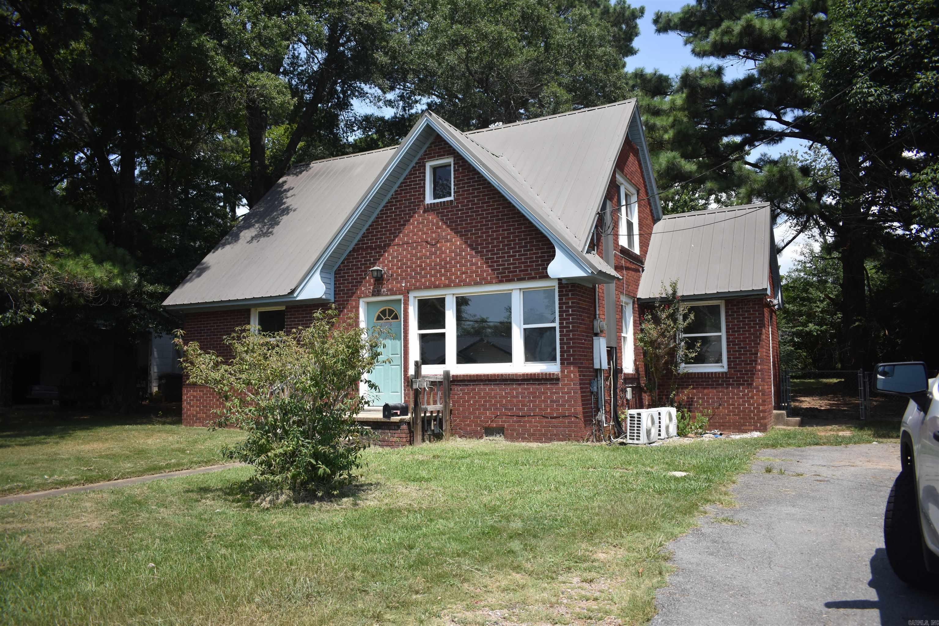 Older brick home with lots of character. This home has two bedrooms downstairs and a large bonus rm upstairs that could be a 3 bedroom. Home has hardwoods floors downstairs that will need reworked. House does have replacement windows and a metal roof.