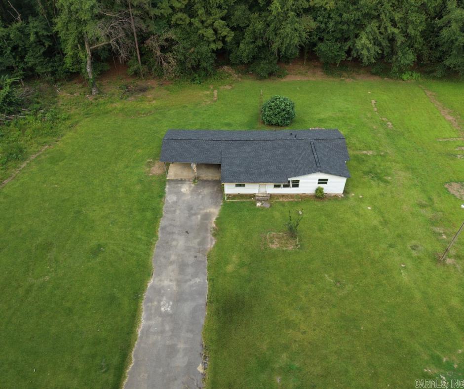 Tucked away on approximately 2 quiet acres in Sparkman, this little country fixer-upper is the kind of place that just needs the right person to see what it could be. With no neighbors in sight, a wide open yard, mature trees, a long driveway, and a peaceful setting, it already has the privacy and space so many buyers are looking for. The home is believed to date back to the mid-to-late 1960s and has already had a few important updates started, including a new roof and fresh paint. Inside, it is ready for someone to bring fresh ideas, finishing touches, and a little love. The property also includes an extra water line, adding flexibility for future use. Whether you are dreaming of a quiet homestead, weekend getaway, investment project, or a place to create your own little country retreat, this one has the bones, the land, and the setting to become something special.
