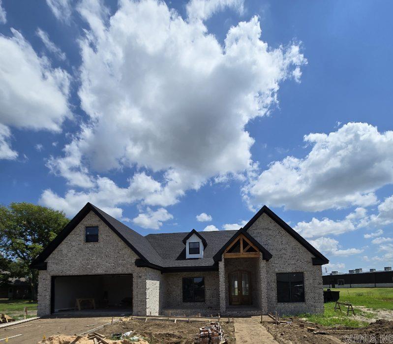 Welcome to Market  1207 Sutton St Manila, Arkansas!  This beautiful new construction home offers 1,650 sq ft of thoughtfully designed living space on a spacious 0.80-acre lot!  All-brick, combines quality craftsmanship with modern style and everyday comfort. Step inside to an inviting open floor plan featuring a stunning vaulted living room accented with decorative wood beams and a beautiful LED fireplace that creates a warm, elegant focal point. The kitchen is designed for entertaining with a breakfast bar, abundant cabinetry, and a pantry. Want peace of mind during a tornado warning?  This beauty has a Built-in safe room to provide added peace of mind!  Enjoy outdoor living on the covered back patio overlooking the generous backyard. With timeless curb appeal, quality finishes, and on a desirable 0.80-acre lot, this one is a looker!