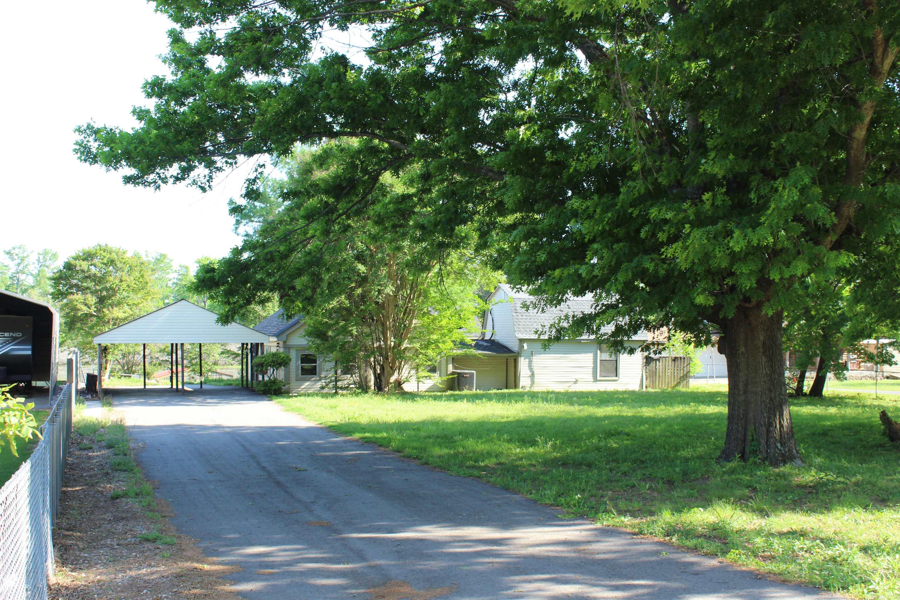 This home is Unique, features 2-bedroom, 2-bath situated on nearly half an acre along the Old River.  It has so much potential to make it your own. The home features an open living area with abundant windows offering beautiful water views, luxury vinyl flooring, sheetrock, and fresh paint throughout. An additional room, accessed by an exterior staircase, provides flexible space ideal for storage or an art studio, also with scenic river views. The property includes an oversized two-car carport, a newly constructed ramp leading to the private boat dock.  A perfect spot for bird watching, fishing, boating, or simply relaxing by the river.—a private boat launch area is available for home owners on Old River     COME SEE!!!   SEE AGENT REMARKS!