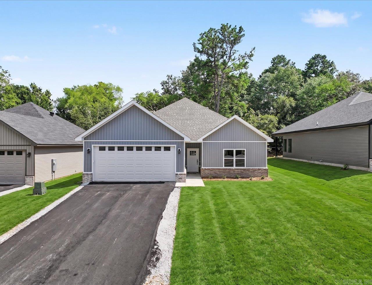 Discover this brand-new home in one of the most desirable areas off Marion Anderson Rd-located in the coveted Lake Hamilton School District and out of the city limits! Step inside to an inviting open floor plan, soaring vaulted ceiling, and a show-stopping designer LED electric fireplace that elevates the living space. Luxury touches are found throughout, including a modern neutral color scheme, white quartz surfaces, 9 ft ceilings, His/Her walk-in closets, and solid core interior doors for that high-end feel. Thoughtful upgrades set this one apart-automatic closet lighting adds convenience, while auto defrost bathroom mirrors provide a spa like experience everyday. The kitchen is fully equipped with all appliances, making this home move in ready from day one. Starlink internet. Agent/Owner.