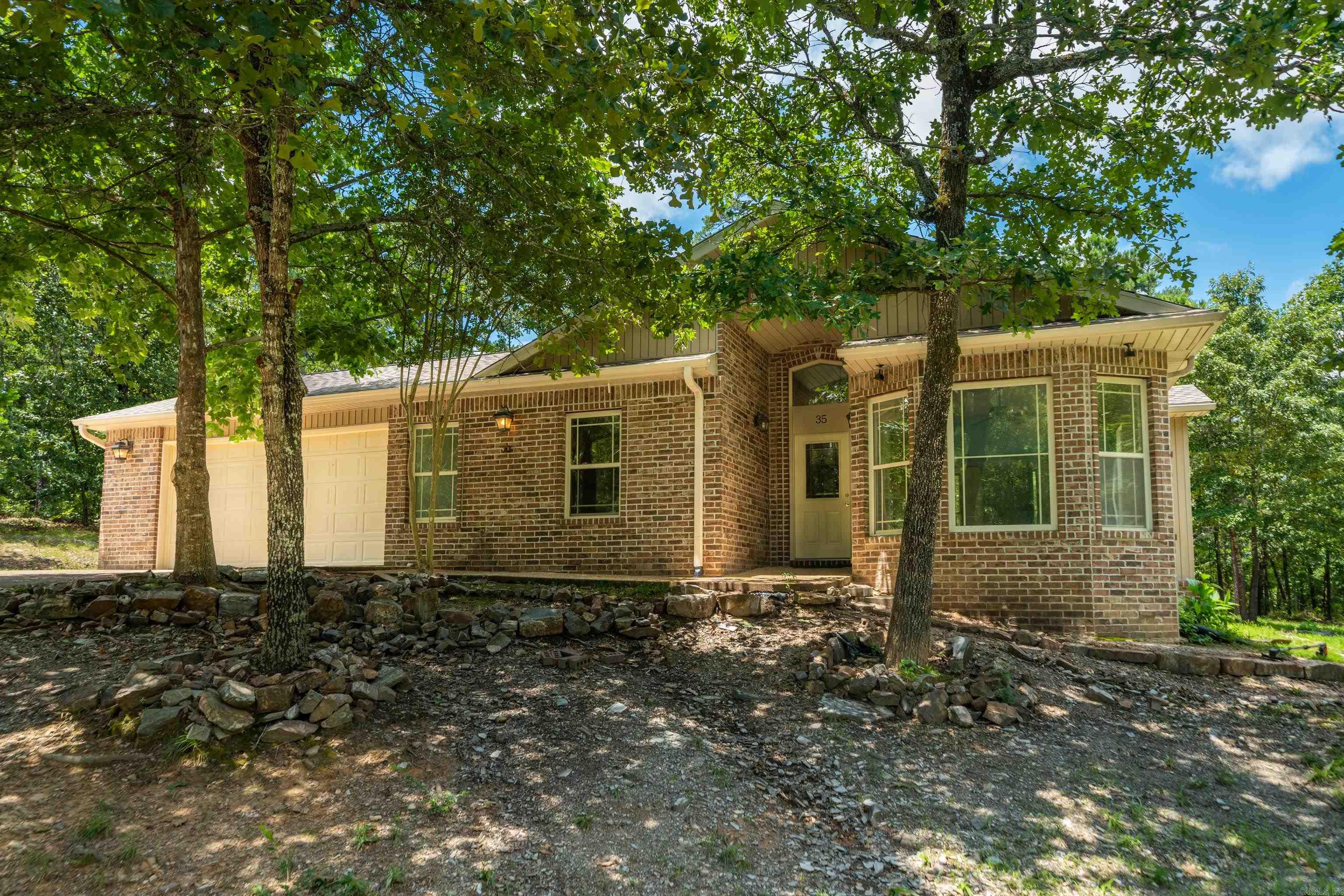 Move-in ready and completely refreshed! A sanctuary tucked away in a serene, wooded setting where you cannot see your closest neighbor. This meticulously maintained home features fresh neutral paint throughout, new carpet and a brand-new roof (2026) for ultimate peace of mind. The open layout features a cozy gas fireplace (needs minor repair/servicing) and an elevated kitchen equipped with instant hot water at the sink. Both bathrooms offer upscale comfort with installed bidet toilets. Just 5 minutes from the Balboa Golf Course and beach. Enjoy total privacy with all the premier gated amenities of Hot Springs Village right at your fingertips. Mineral rights, if any, do not convey with the sale of this property. MOTIVATED SELLER!! Schedule your showing today! Contact agent!