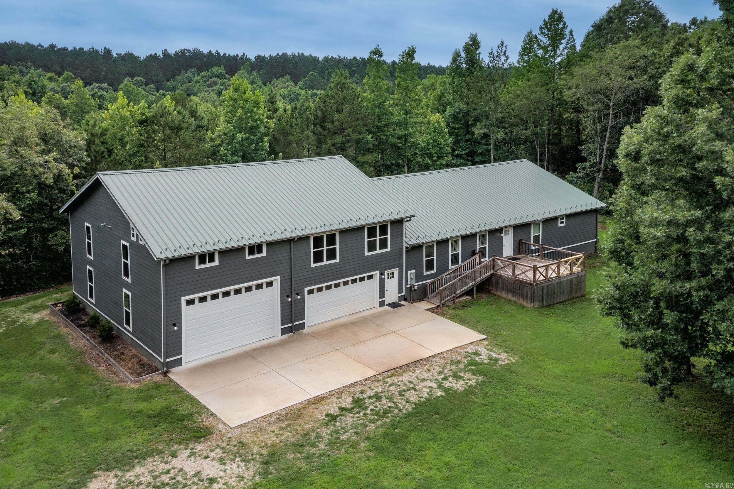Built in 2022 this home is situated on 1.3 acres and has room for everyone!  Main house is one level open concept with LVP floors and gorgeous fireplace.  Guest quarters over garage has full kitchen and laundry area.  4 car tandem garage with doors on both sides PLUS a full RV parking garage!  Metal roof and Hardie board siding offer a low maintenance lifestyle while enjoying the privacy this property provides.