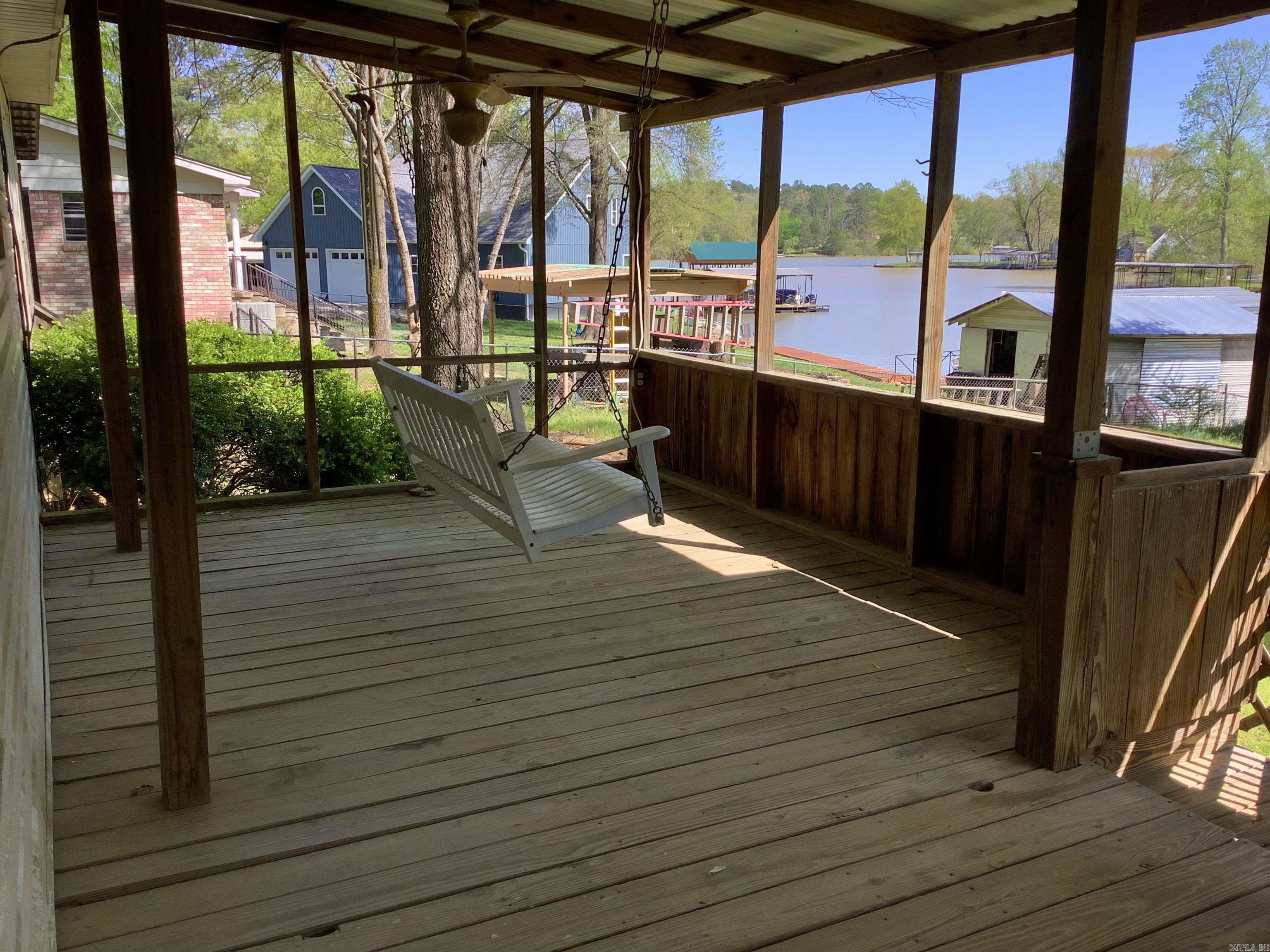 3 bedroom, 2 bath on LAKE HAMILTON with covered boat dock and 101 feet of lake frontage. This mobile home has an open floor plan, wood burning fireplace, 2 dining areas, plenty of cabinets, a large master suite with french doors that lead to a spacious bathroom with soaking tub and walk-in shower. Back yard is partially fenced with a slight slope towards the water. Carport and side-driveway for parking. Enjoy the lake view while swinging on the large covered back deck.