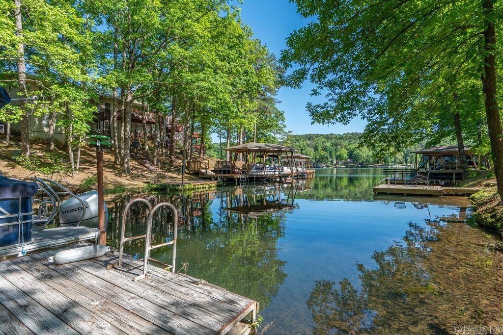 Lakefront living meets investment opportunity on beautiful Lake DeSoto! This fully furnished (minus a few personal items), 4-bedroom, 3-bath end-unit townhouse offers 2,276 sq. ft. of completely remodeled space designed for comfort, style, and relaxation. Professionally redesigned with high-end finishes throughout, this property is move-in or rental ready. Enjoy stunning lakefront views from the newer upper deck or lower patio, both perfectly positioned for entertaining or unwinding by the water. Upstairs, you'll find a split floor plan with 3 bedrooms, 2 full baths and a beautifully remodeled kitchen featuring quartz countertops, tile backsplash and new appliances. You are sure to appreciate the new easy-to-clean LVT flooring, wood burning fireplace and extra storage throughout. The lower level includes a second living space, perfect for hosting as it comes equipped with a kitchenette, ping pong table, extra-large bedroom, full bathroom, new windows, and new sliding glass doors leading to the lakeside patio. HVAC 2021, Roof 2026, 2 Hot water heaters 2026. Whether you’re searching for an Airbnb investment, vacation retreat or full-time residence, this property checks every box.