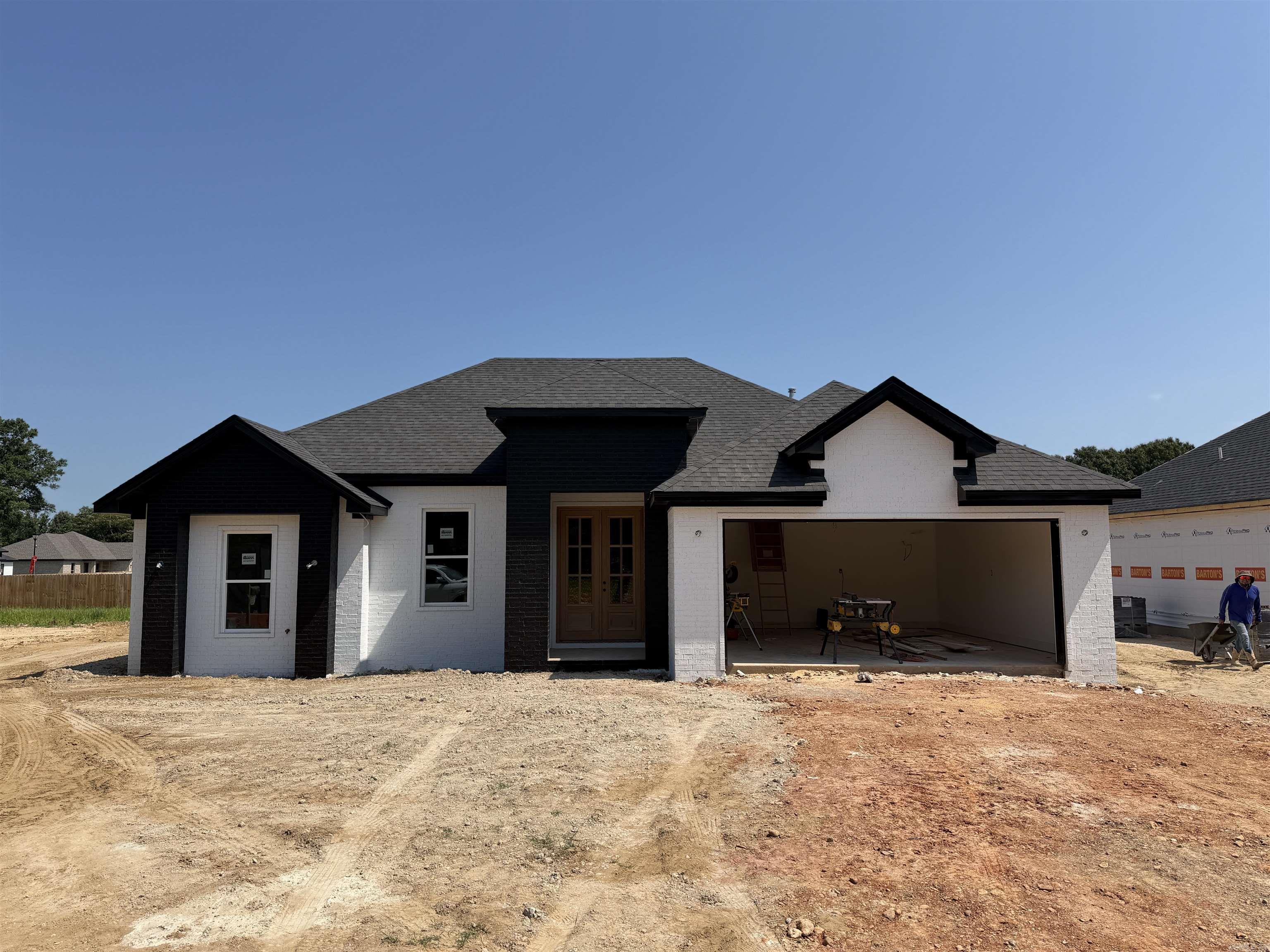 Under Construction!!     Welcome to Market 603 Cayson St in Bono, Arkansas!   Here you will find that Quality craftsmanship and timeless finishes come together in this thoughtfully designed new construction home!  Offering 1,450 sq ft, 3 bedrooms, and 2 baths, the floor plan makes excellent use of space while providing comfortable everyday living. The vaulted living room has decorative wooden beams.  Interior decadent black brick accent wall offers subtle definition between the living room and kitchen. The kitchen features antique white cabinetry, a breakfast bar, a gas range & wall oven. The primary suite includes a custom walk-in tile shower, and the interior safe room adds an extra layer of security. Enjoy the convenience of a covered back patio and a fully fenced backyard.  This is Built with attention to detail and designed for lasting appeal, and will be completely ready for its first owners.