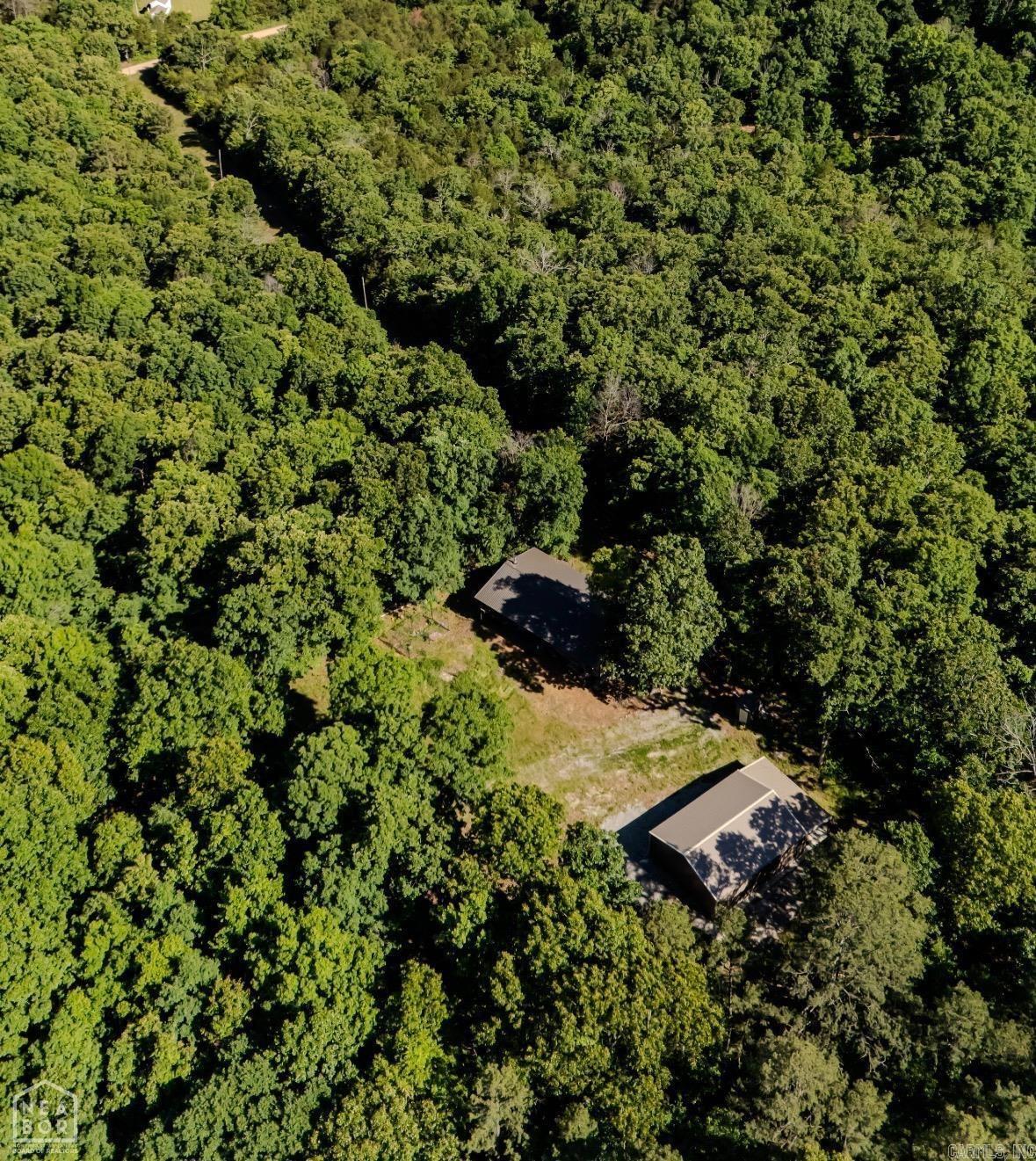 Beautiful rolling acreage in the heart of Randolph County just outside of Pocahontas! Whether you are looking for a hunting retreat, weekend getaway, or a permanent place to call home, this 82 +/- acre property offers including approx 1/3 of acre pond on the proerty. This property offers the perfect combination of privacy, comfort, and country living. The property features a cabin/home with rustic charm throughout, including cedar walls, acid stained concrete floors, and an open kitchen and living area centered around a wood-burning stove. The home offers two bedrooms plus a study currently being used as a third bedroom, two full bathrooms, a laundry room, and garage space currently set up as a game area with a pool table. Additional features include an on-demand gas water heater, foam-insulated walls and roof, blown-in cellulose insulation in the attic, fiber optic internet, well water with water softener, Clay County Electric, and MFA propane with a leased tank currently costing approximately $25 per year. The current owner typically uses about one tank annually. Outside, the property includes a 30x40 shop with a 12ft lean-to, offering plenty of room for equipment, storage.
