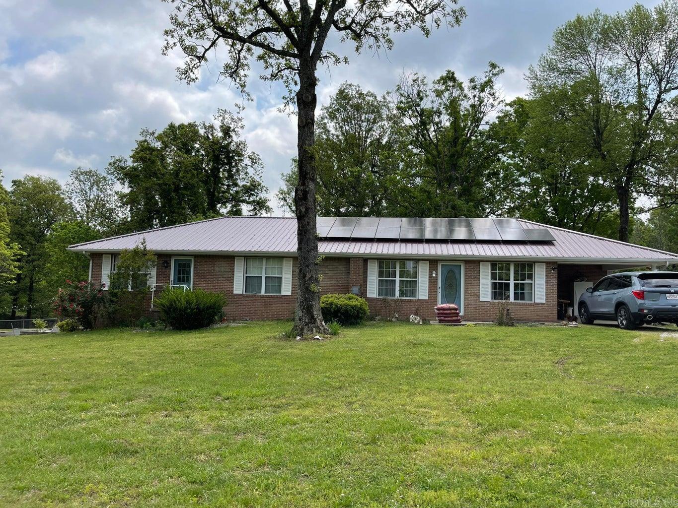 Mini farm with well maintained 3 Bedroom, 3 Bath, brick home on 5 un-restricted, fenced, cross fenced acres with pond located less than 4 miles from Ash Flat. Home features walk out basement, dedicated laundry, office which could be a 4th bedroom, new kitchen, flooring, metal roof new in 2018, new HVAC installed in Dec 2019, new solar panels in 2021, and privacy fencing along highway. Large back deck that's perfect for backyard living! Extra storage in the detached garage/ shop, along with the 10 x 16 Bald Eagle Barn She Shed. There is a 40 X 40 barn for livestock or hay with electric and water. Chicken coops already established and fenced areas for them as well as your fur babies. - This is now a short sale.