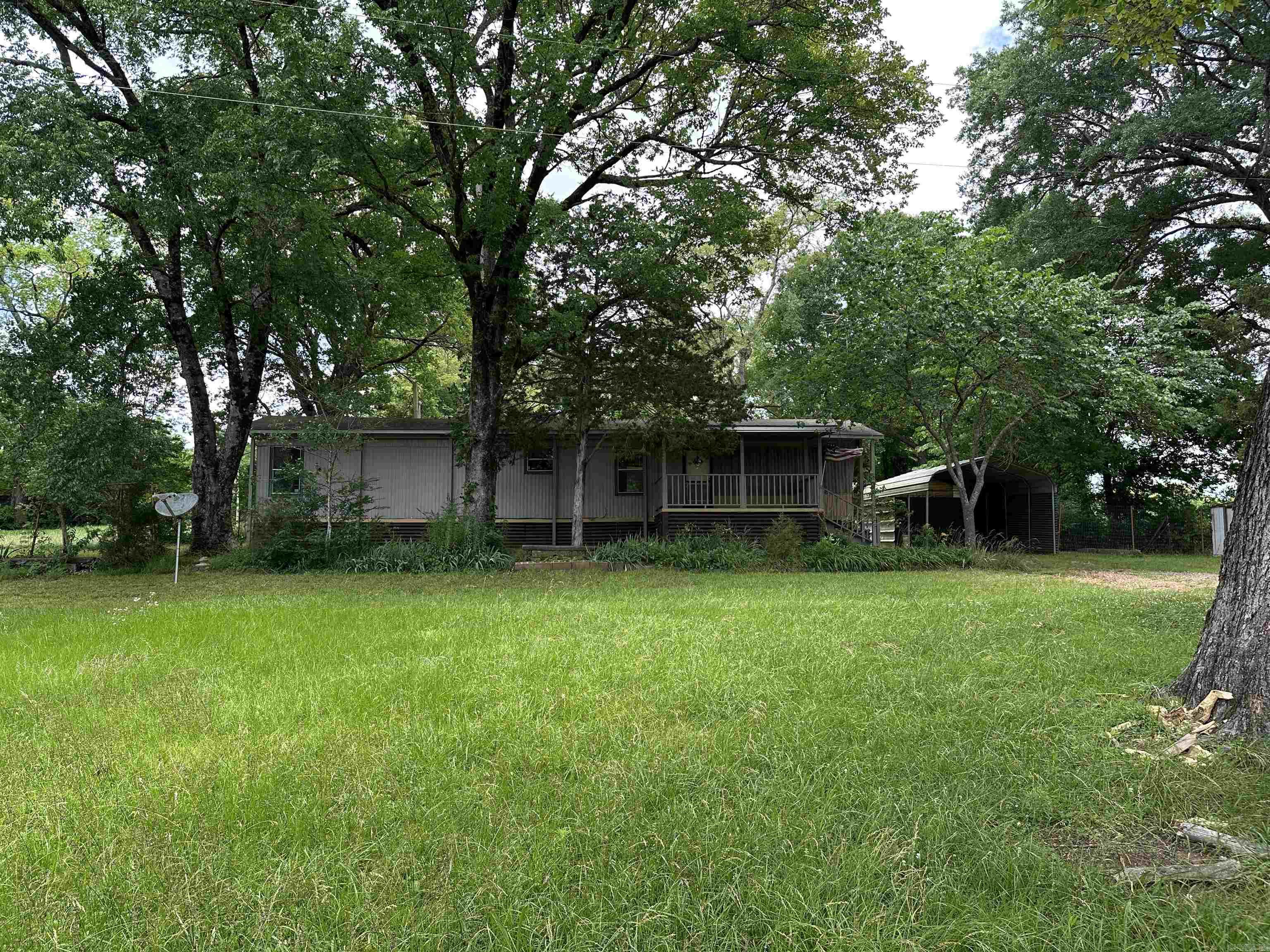 Cute little two bedroom mobile home sitting on .76 acres in downtown Point Cedar, AR.  Easy access to Hot Springs.  Move in ready.  Canopy roof and detached metal carport.  All appliances convey.  Commercial possibilities.  Lake DeGray Shouse Ford landing is just minutes away.