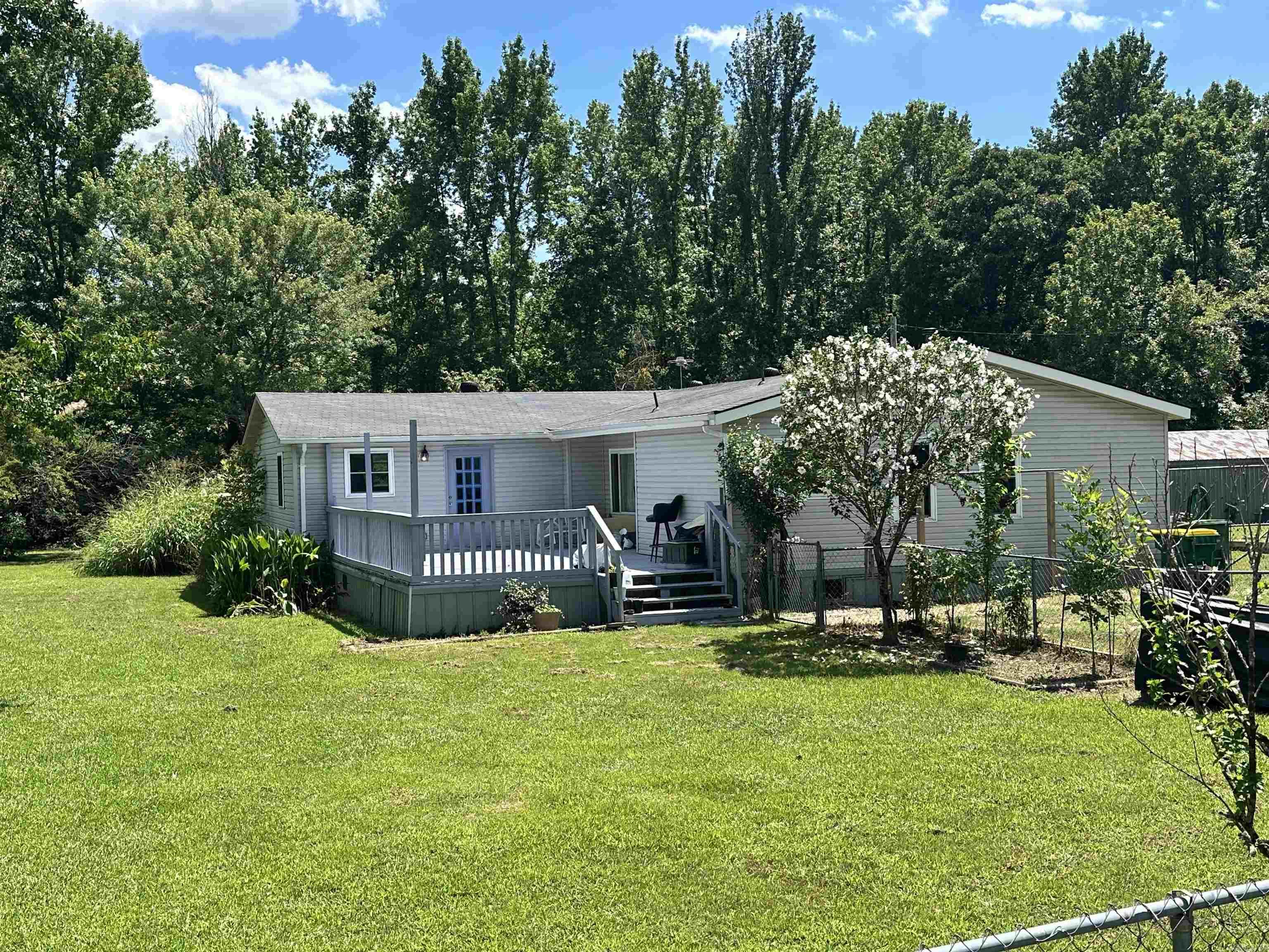 Looking for nearly 1.5 acres just outside of Cabot? Look no further! Conveniently located near the LRAFB, this manufactured home on permanent foundation offers space, comfort, and incredible outdoor amenities. Situated on a fully fenced, tree-lined corner lot, the property features RV hookups, a powered shop and storm shelter with electricity. Inside, you'll find spacious kitchen with wraparound cabinetry, providing abundant storage. The inviting living room boasts vaulted ceilings, a cozy wood burning fire place, and a stained planked wooden accent wall that creates a warm, rustic feel. Don't miss your opportunity, schedule your showing today!  (Showings will start on Saturday) *** Professional pictures coming soon ***