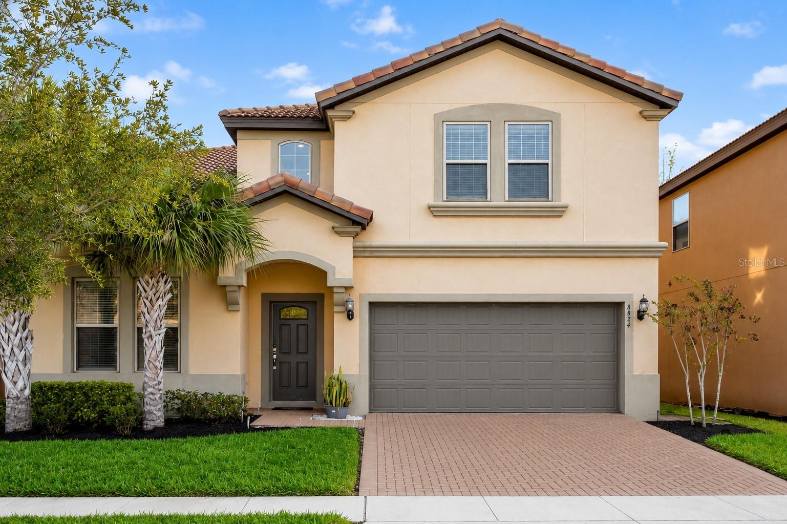Welcome to 8824 Bengal Court, a FULLY FURNISHED 8-BEDROOM, 6-BATHROOM home in the prestigious GUARD-GATED WINDSOR AT WESTSIDE RESORT. Built in 2019, this exceptional property is ideal as a PRIMARY RESIDENCE, VACATION HOME, or INCOME-PRODUCING SHORT-TERM RENTAL, offering luxury, versatility, and resort-style living.

As you arrive, you'll immediately notice the attractive curb appeal and welcoming entrance. Step inside to a grand foyer where SOARING CEILINGS, abundant natural light, and stylish furnishings create an inviting first impression. The OPEN-CONCEPT FLOOR PLAN seamlessly connects the main living areas, making it perfect for entertaining and everyday living.

At the heart of the home is the GOURMET KITCHEN, featuring GRANITE COUNTERTOPS, STAINLESS STEEL APPLIANCES, ample cabinetry, and an OVERSIZED BREAKFAST BAR overlooking the dining area and spacious living room.

The first floor offers TWO PRIMARY SUITES, each with PRIVATE EN-SUITE BATHROOMS and WALK-IN CLOSETS, providing comfort and privacy for owners and guests. A FIRST-FLOOR LAUNDRY ROOM adds everyday convenience.

Upstairs, the expansive LOFT offers flexible space for a game room, media room, or second living area. Additional generously sized bedrooms and full bathrooms comfortably accommodate large families or vacation guests.

Step outside to your private retreat featuring a SCREENED-IN POOL AND SPA and a COVERED LANAI, creating the perfect setting for relaxing, entertaining, or enjoying Florida's year-round sunshine.

Residents and guests enjoy WORLD-CLASS RESORT AMENITIES, including a BEACH-ENTRY POOL, LAZY RIVER, WATER SLIDES, CLUBHOUSE, FITNESS CENTER, ARCADE, PLAYGROUND, SPORTS COURTS, and a POOLSIDE BAR & GRILL.

Conveniently located just minutes from WALT DISNEY WORLD, major attractions, shopping, dining, ORLANDO INTERNATIONAL AIRPORT, and major highways, this home offers exceptional accessibility.

Whether you're looking for a luxury getaway, full-time residence, or turnkey investment, 8824 Bengal Court delivers the space, location, and lifestyle buyers are searching for. Schedule your private showing today!