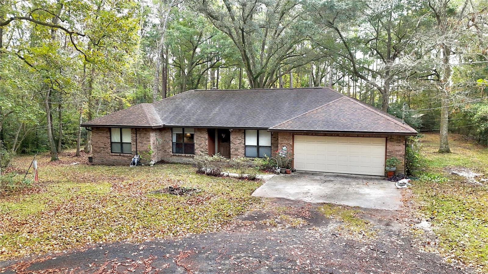 This sizeable acreage property in Duval County offers a unique combination of house, land, and natural features near Jacksonville. The main residence is a 3–bedroom, 2–bathroom brick home built in 1987, with approximately 3,200 square feet under roof and about 2,600 square feet heated and cooled. The living space is open with high ceilings, and a wood-burning fireplace provides a cozy focal point. A 200-square-foot Florida room overlooks the backyard and pool, offering a pleasant view of the grounds.
The property extends beyond the house. It sits on one of the larger privately owned parcels in the area, giving significant acreage for family use, recreation, or — depending on planning and zoning approvals — potential for additional homesites or development. A continuously flowing creek runs the entire length of the tract, offering a natural feature that enhances privacy and ambiance. Mature large oak trees and longleaf pines form a buffer between this property and surrounding developments, contributing to a secluded feel even though the property is close to urban infrastructure.
Access to the property is very convenient. It lies less than a mile from I-295 and about one mile from I-10, providing quick routes to downtown Jacksonville and major regional locations. The driveway is a winding asphalt millings driveway, which leads through the property and connects to the main road, supplying a private drive to the home and outbuildings. On-site there is also a 24-by-30-foot metal building that can serve as storage, workshop, or utility building depending on owner needs.
Outdoor amenities include a private pool and the natural creek frontage, along with ample open land shaded by mature trees. The house’s layout and amenities make it suitable as a comfortable residence while the generous acreage offers opportunities for outdoor recreation, gardening, estate-style living, or subdivision — if allowed by future planning and zoning. Its location places the property within the Duval County school system, with schools close by. Meanwhile, shopping, restaurants, and urban conveniences are just around the corner, and downtown Jacksonville is only minutes away.
This listing combines a substantial residence with wide open acreage and a mix of natural and developed amenities. The creek, wooded buffer, and open land provide a sense of privacy and potential, while the house, pool, driveway, and storage building supply ready-to-use infrastructure. For buyers seeking acreage near Jacksonville with living space, land, natural features, and flexibility for future use, this property offers a noteworthy opportunity.