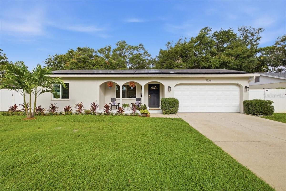 Welcome to this beautifully updated home in the heart of northeast St. Petersburg, offering the perfect blend of style, functionality, and energy efficiency.  Wood-look PORCELAIN PLANK FLOOR TILE flows seamlessly throughout the home, complementing the OPEN-CONCEPT floor plan and abundance of NATURAL LIGHT from numerous windows. The renovated kitchen is designed for both everyday living and entertaining, featuring ample storage, GLASS-FRONT DISPLAY CABINETRY, a dedicated COFFEE BAR, separate WINE BAR with BEVERAGE REFRIGERATOR, counter-height BAR SEATING, and newer appliances that all convey. Multiple living areas provide exceptional flexibility for today's lifestyle, offering endless possibilities for gathering, working, relaxing, or creating dedicated hobby spaces. The spacious 200-square-foot primary suite easily accommodates a sitting area, home office, vanity space, or nursery. The beautifully updated ensuite bathroom features a walk-in shower, modern illuminated touchscreen mirror, and large storage niche. The guest bathroom has a tub and shower and has also been fully and tastefully renovated.  Step outside to enjoy the oversized lot with FRESH SOD, paved rear PATIO, and a white vinyl PRIVACY FENCE - ideal for outdoor entertaining, pets, or play and plenty of room for a pool.  Major system upgrades provide peace of mind and long-term savings, including a newer roof, fully paid-off solar panels, newer HVAC system, tankless gas water heater, whole-home gas generator, updated windows and doors, garage door opener, and newer appliances. ROOF 2022. HVAC 2020. WHOLE-HOME GENERATOR 2020. SOLAR 2019. GAS TANKLESS WATER HEATER 2019. WINDOWS & DOORS 2016 and 2026. BATHROOMS 2026. WINE BAR & COFFEE BAR 2026. FLOORING 2026. CEILING FANS & LIGHT FIXTURES 2026.  Conveniently located just minutes from schools, shopping, dining, and Interstate 275, this move-in ready home offers comfort, efficiency, and versatility in one of St. Petersburg's most convenient locations. NO HISTORY OF FLOODING.