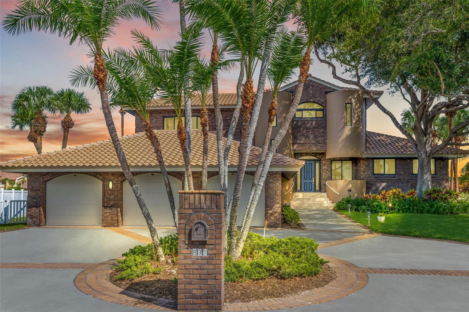 Welcome to a beautiful waterfront home in coveted Tierra Verde. This unique contemporary brick structure enjoys a commanding presence of 133 feet frontage along the prestigious Grand Canal. The Grand Canal offers the fastest, most convenient gulf access in Pinellas County. This one of a kind location features breathtaking views and the ability to accommodate a very large vessel. The front entry through a walkway shaded by 50 year old oak trees, dramatically displays the quiet privacy of this home.  Anchored by a huge kitchen with island and extensive bar space the open-floor plan connects the living room, dining area, and kitchen, creating an ideal space for entertaining on a grand scale. The dining area and great room have access through sliding glass doors to the back patio overlooking the pool and the water. A large laundry room is located just off the kitchen and features abundant cabinet storage. The north wing of the first floor houses four bedrooms which may alternately be used for a home office, gym, or card room. There are two Jack and Jill bathrooms shared by each pair of bedrooms. The bedrooms and bathrooms encircle a large (19X20) bonus room which is currently configured as a media room with theater seating and large screen TV. The second level is accessed by stairway or convenient elevator. Four areas occupy the upper level. A private terrace with views of the water runs the entire length of the upper level. The terrace is easily accessed from the primary suite through sliding glass doors inviting you to indulge in the serene surroundings. Two walk-in closets provide abundant storage. The luxurious, en-suite bath is a sanctuary of relaxation, with double sink vanity, a walk-in shower, and a private water closet. A bonus room which includes a small bar/kitchen and full bath occupies the north end of the upper level. It is currently configured as an artist's studio, but has enjoyed use as a billiards room and a trophy room complete with gun storage and big game trophies and could be easily configured as a mother-in-law suite or gym. The final feature of the upper level is a large water view room which enjoys access from both the bonus room and the master suite, conveniently serving as an office or nursery. From the great room the three car garage is reached by stairway and hall where you will pass two large closets an additional reminder that this home has an enormous amount of storage. The outdoor living spaces are designed for relaxation and entertainment. A spacious terrace overlooks the deck, fire pit, pool, and spa, providing the perfect spot for al fresco dining, lounging, and partying. Situated in Pinellas County's premier waterfront community, this home offers everything one could hope for in the Florida waterfront lifestyle. Enjoy quick and convenient boating access to the Gulf of Mexico, embracing the pinnacle of waterfront living. Impeccably maintained the new owner will enjoy the benefits of new hurricane impact doors and windows, a new tile roof and recent ACs.