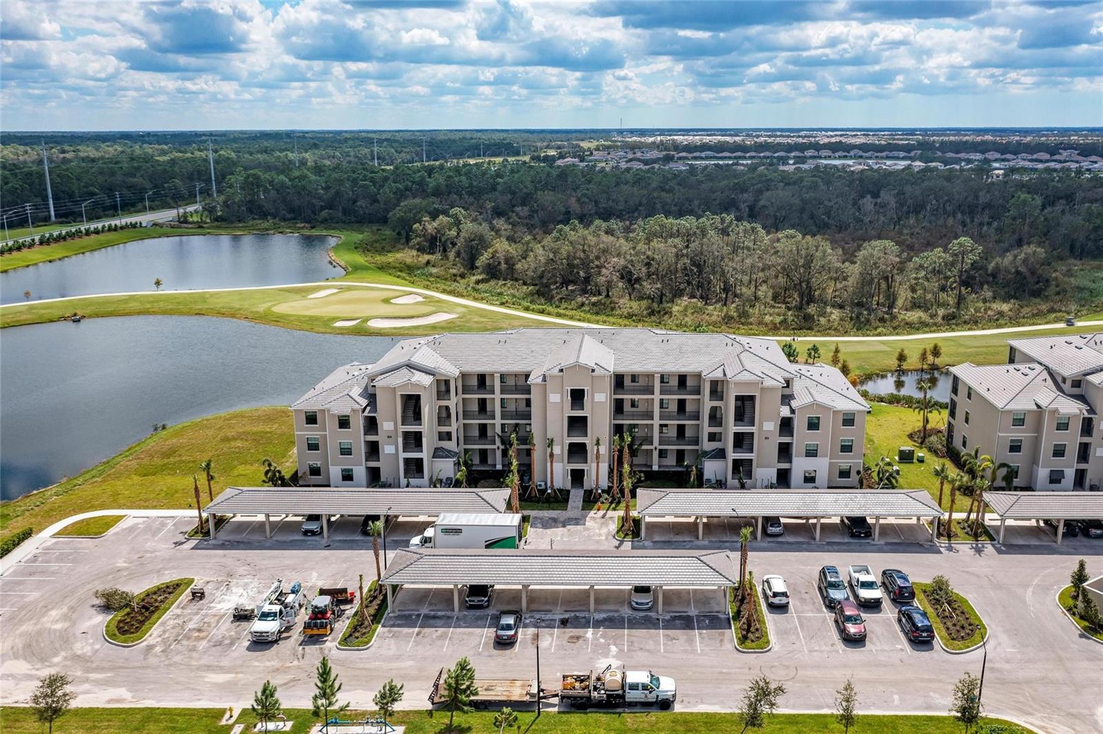 Welcome to Your Resort Lifestyle at Lakewood National
This exquisite 2-bedroom, 2-bathroom condo sets a new benchmark for luxury in Lakewood National, offering a level of custom sophistication that is truly rare. Completed in August 2022, this relatively new construction residence has been transformed with high-end designer finishes that differentiate it from every other unit on the market. The journey begins in the upgraded entryway featuring custom molding, leading you into a dining space enhanced by floor-to-ceiling mirrors that beautifully expand the natural light. The heart of the home is the stunning kitchen, which boasts a custom tile backsplash, under-cabinet lighting, and an island detailed with elegant custom molding.

The living room serves as a show-stopping focal point with its own custom feature wall and a functioning electric fireplace, perfect for cozy evenings. This refined aesthetic continues into the primary suite, where a bespoke focal wall creates a serene and upscale atmosphere. Every inch of this home has been thoughtfully decorated to deliver a high-touch, polished feel that complements the lush views of the championship 36-hole golf course visible from your screened lanai. For those seeking a seamless transition, select furnishings are available, making this a truly move-in-ready opportunity.

Residents of Lakewood National enjoy an unparalleled amenity package, including the Arnold Palmer designed golf courses, a resort-style lagoon pool with a poolside tiki bar, a full-service spa, and a state-of-the-art fitness center. Combining the benefits of newer 2022 construction with bespoke interior upgrades, this condo offers a premium lifestyle in one of Florida’s most prestigious communities.

Beyond the gates, you are just moments away from the premier shopping, fine dining, and entertainment that Lakewood Ranch is famous for. This property is not just a residence, but a gateway to the active and luxurious lifestyle you have been dreaming of.