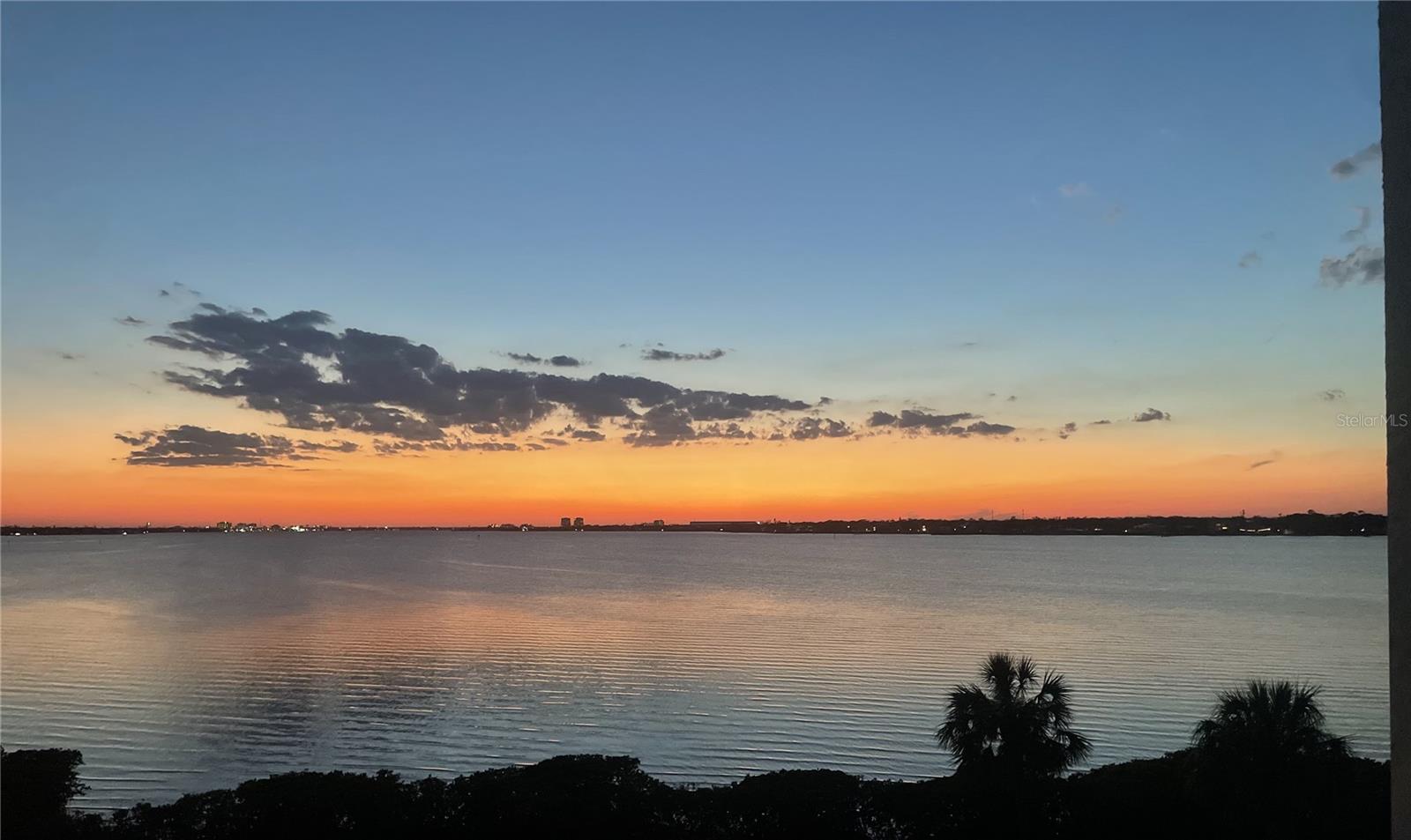 Sunset after beautiful sunset!! Bask in the stunning views of sunset over the Manatee River from this third floor, corner unit in Tidewater Preserve.  Park in your designated, covered parking spot - right in front of the building. Get your steps in on the stairs, or ride the elevator to your peaceful end unit, only attached on one side with no neighbors above you. One of the few units with 3 bedrooms, this freshly painted condo also has two full baths, an open designated dining room, in-unit full size washer and dryer and newly installed automated 100 percent dark out blinds. The open concept design allows for seamless entertaining from the kitchen to the screened in balcony. Tidewater Preserve is a gated waterfront community with a 24 hour security guard. It holds a private marina with docks, allowing for direct access to the Manatee River. The condominiums on the water have their own private pool,  as well as access to the main clubhouse, community pool, two fitness centers, community room with catering kitchen, pool table, tennis courts, canoe and kayak launch with storage, and a beautiful walking trail. An impeccably well maintained community, with all the amenities needed to relax and feel at home! A new sunset every evening awaits you
