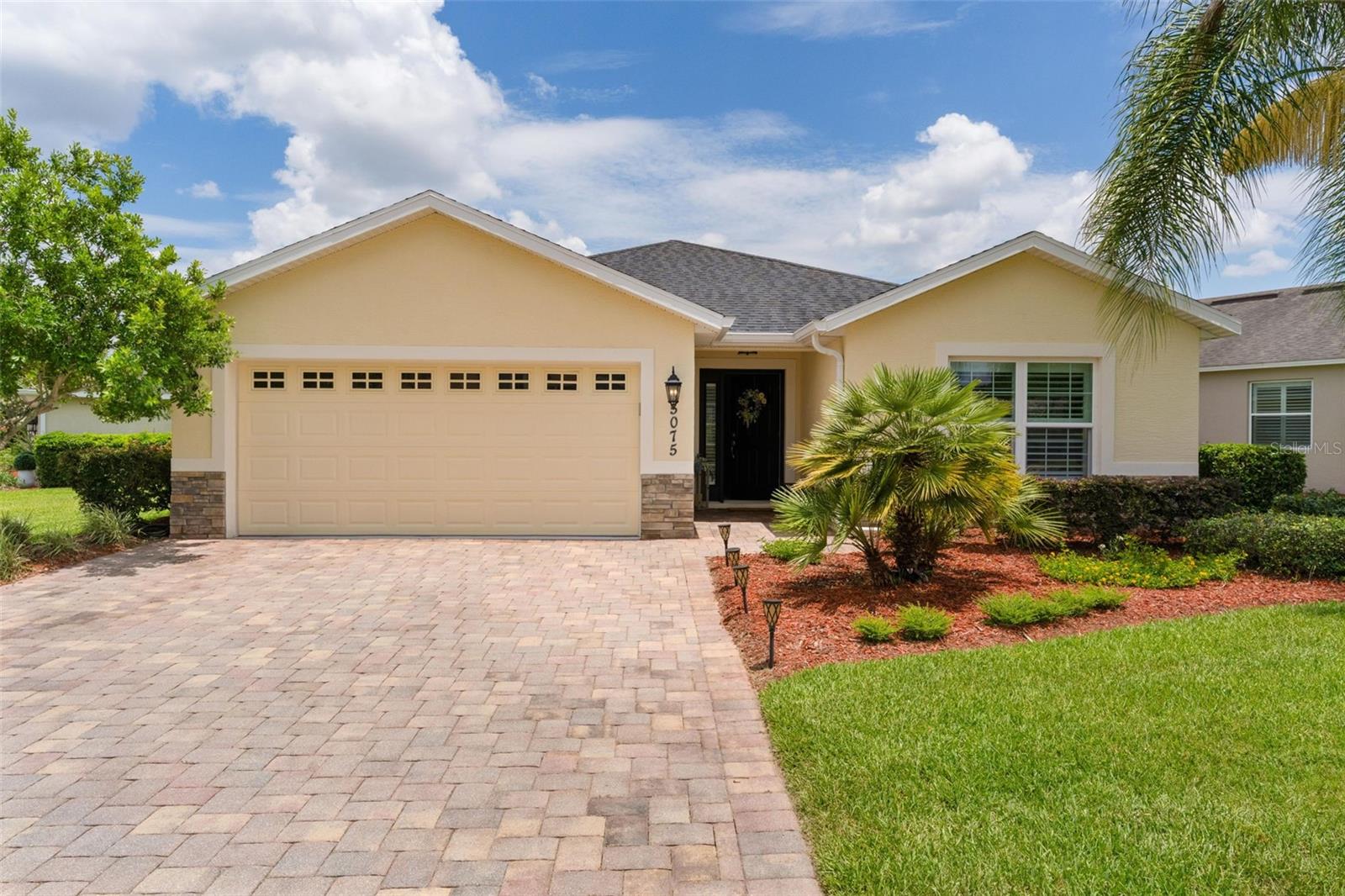 Experience luxury resort-style living in the highly sought-after Lakeside Landings community, ideally located adjacent to The Villages and just minutes from premier shopping, dining, and nightly entertainment. This meticulously maintained and gently lived-in 2-bedroom, 2-bath home with a 2-car garage is being offered turnkey—simply bring your personal belongings and begin enjoying this exceptional lifestyle.
Inside, you’ll find plantation shutters, ceramic tile flooring, soaring ceilings, and a convenient indoor laundry room. The open-concept kitchen is well-appointed with stainless steel appliances, Corian countertops, abundant storage, and light-toned cabinetry that enhances the bright and airy feel of the space. The spacious primary suite features a large walk-in closet, private en-suite bath with dual vanities, a walk-in shower, and direct access to the screened lanai. The generously sized guest bedroom offers its own closet, like-new carpeting, and access to a dedicated full bath with attractive tiled shower accents. Lakeside Landings distinguishes itself with its impressive resort-style amenities, including a spectacular community pool, clubhouse, fitness center, card room, library, and multipurpose conference/party room. Residents enjoy an active social calendar, friendly atmosphere, and a welcoming environment for both retirees and families alike. Don’t miss this opportunity to own a beautiful turnkey home in one of the area’s most desirable communities. Schedule your exclusive showing today!