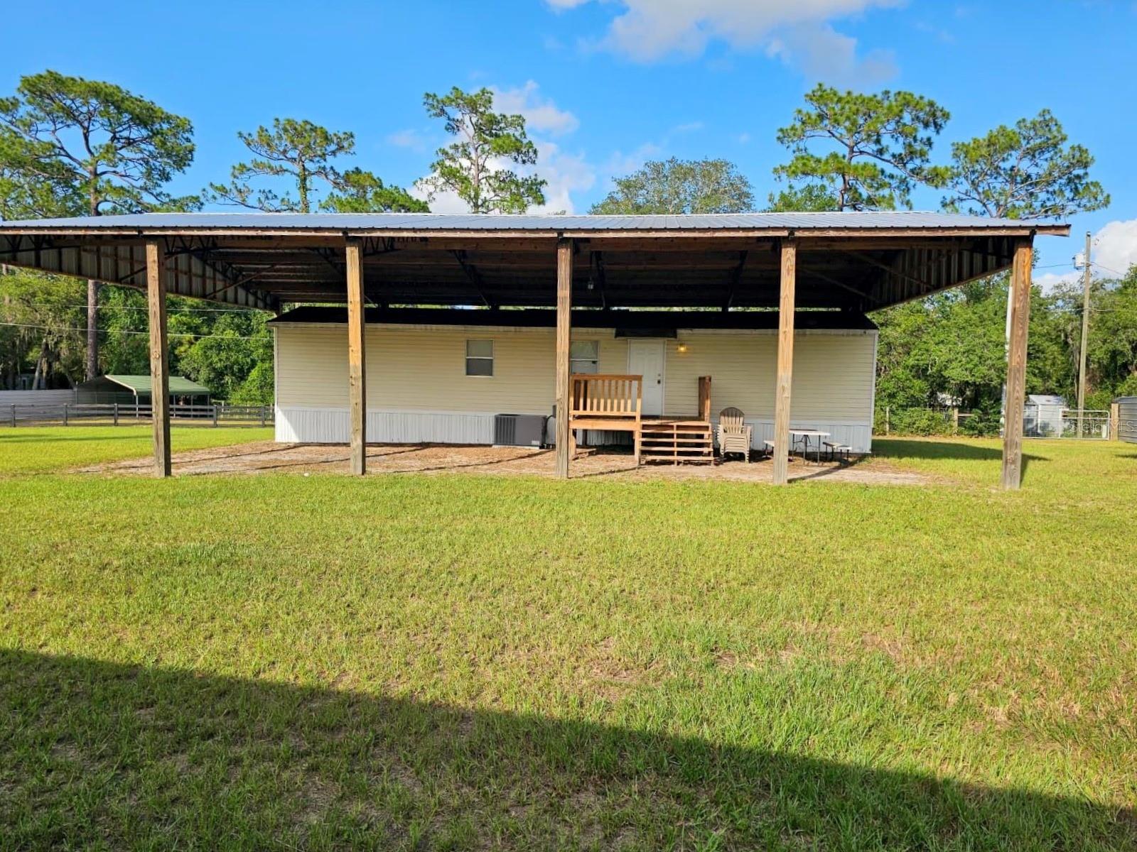 Welcome to your private retreat in Forest Lakes Park! This well-maintained 2003 single-wide home features 2 bedrooms, 1 bathroom, and sits on .83 of an acre with a fully fenced corner yard. The home is protected by a 60' x 40' pole barn built in 2024, offering excellent covered space for vehicles, equipment, or outdoor entertaining.

Recent updates include a new well (2018), central A/C and heat with Wi-Fi thermostat (2017), hot water heater and flooring (2021), wood front porch, new fencing and gates (2023), and a lime rock driveway (2024). The cleared corner lot offers two gated entrances, a horse turnout with shelter (2023), a 40-foot Conex storage container, and a fire pit with seating area.

The backyard borders the Ocala National Forest (Big Scrub), providing direct access to horseback riding, hiking, hunting, birdwatching, and other outdoor recreation. Nearby spring-fed Lake Mary is perfect for swimming, kayaking, and paddleboarding. Conveniently located just 40 minutes from Lake George and 25 minutes from The Villages, this property is ideal as a full-time residence, weekend getaway, or recreational retreat.

Bring your horses, ATVs, boats, and outdoor toys, this move-in-ready property is ready for you to enjoy!

Schedule your private showing today!