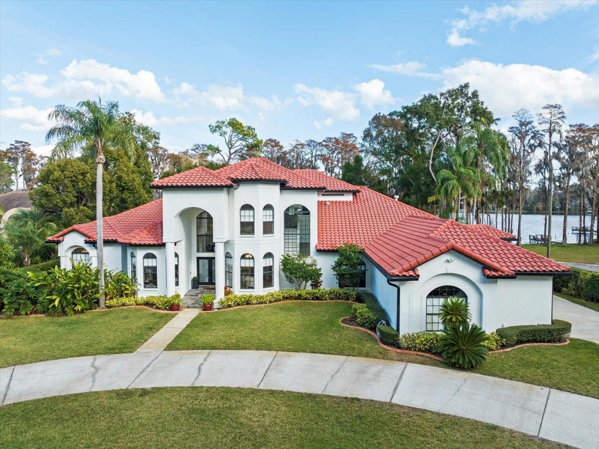 Discover unparalleled elegance and peaceful tranquility in this magnificent estate, located on Rock Lake in Odessa.   This 6-bedroom, 5.5-bathroom privately gated lakefront estate, is a perfect blend of opulence and functionality, this residence offers an array of exceptional features. Nestled on a quiet private road offers the feeling of being out in the countryside while still being near all the amenities with easy access to the city. Right out of the pages of a magazine, this true show home has been impeccably remodeled with designer finishes that reflect genuine pride in ownership! The moment you walk through the front doors into the foyer you will be blown away by the spacious open floor plan, Custom floor to ceiling wainscoting that sets the stage for the grandeur that awaits, natural light that draws your eyes to the glistening lake view and gorgeous luxury custom white oak hardwood flooring that grace the entire home. The remodeled kitchen is a chef's dream, boasting Cambria Britannica Quartz countertops, waterfall edges, two islands, and top-of-the-line GE Monogram Appliances. The custom wooden shelving and hood for the stove add to the culinary allure.
 
The first floor is home to a grand primary suite, featuring a fireplace and an impeccably remodeled bathroom. Revel in Quartz countertops, a freestanding tub, wall-mounted faucets, high-end fixtures, and a Moen Smart Shower with a frameless enclosure, multiple shower heads, and body jets. The adjacent music room, with a large closet, offers versatility as an additional bedroom or office, while the reading room shares a fireplace with the primary suite.
 
The first floor also encompasses an in-law suite with its own private bath and an additional bedroom. Entertainment options abound with a large bonus room, situated off the family room, ideal for a media center, office, or additional bedroom, provides another great vantage point of the pool and lake, with a pool bath for added convenience.
.
The laundry room has been transformed into a stunning space with custom wood shelving, a large central island, and even a custom dog wash bath, making laundry day a true pleasure. Upstairs, two additional bedrooms, a bath, and a loft area offer privacy and comfort.
 
Every living area including the primary suite, centers around the large glass doors leading to the Professionally designed outdoor Paradise with captivating lake views. The lakefront paradise is complemented by a private dock, 2 boathouses with a lift, and a rare private paved boat ramp for this skiable lake.
 
Step outside to the massive covered lanai, adorned with travertine, overlooking the heated pool, spa, and water features that enhance the outdoor activities. The outdoor kitchen nearby adds to the al fresco experience. The entire indoor/outdoor space is wired for zoned surround sound, featuring in-ceiling, mounted, and rock speakers.  The home also comes with a robotic mower that is programmed specifically for the property.
 
Too many updates and features to list all here so please see attached feature sheet.
 
This lakefront masterpiece redefines luxury living. Schedule your private tour today and immerse yourself in the unparalleled beauty of 7223 N Mobley Rd, Odessa. Bedroom Closet Type: Walk-in Closet (Primary Bedroom).