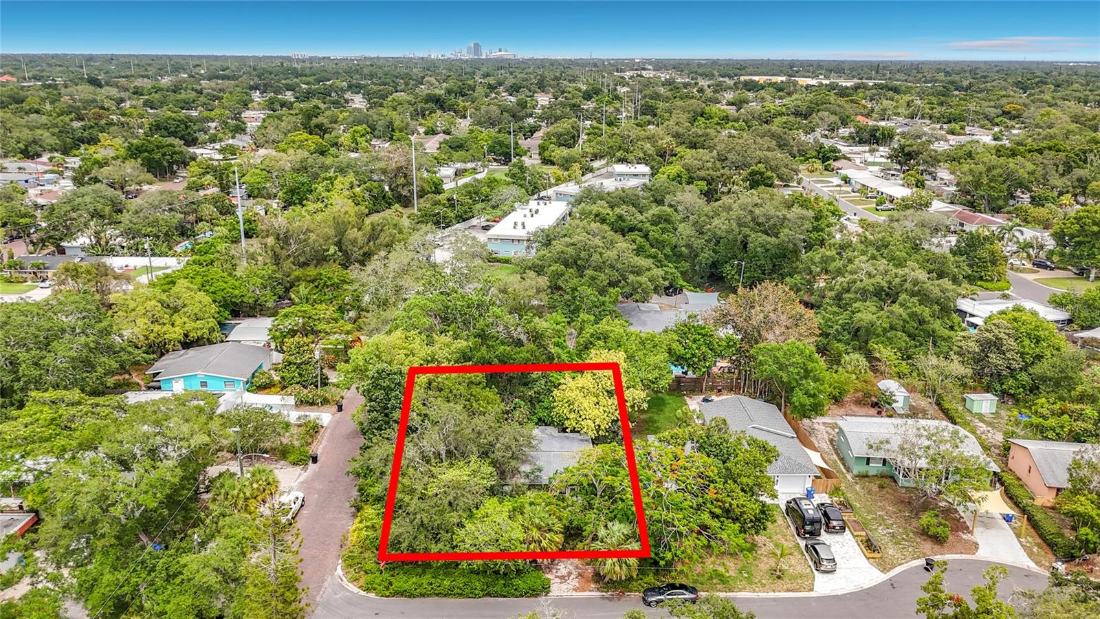 Welcome to your own private tropical retreat in the heart of St. Petersburg. Tucked behind a lush canopy of mature trees, towering bamboo, and vibrant bougainvillea, this charming 2-bedroom, 1-bath home at 6330 Emerson Ave S offers 1,350 square feet of living space and one of the most unique, nature-immersed lots in the 33707 zip code.

Inside, you’ll find an open living and dining layout anchored by a striking white painted brick fireplace a rare find in Florida. The kitchen features granite look countertops, white cabinetry, a gas range, and a charming pass-through peninsula that connects the kitchen to the living area. Both bedrooms are generously sized with tile flooring and ceiling fans, and the enclosed Florida room adds additional flexible living space perfect for a sunroom, studio, or reading nook.

Step outside and the property truly comes alive. A brick paver patio leads to a concrete walkway winding through an enchanting backyard that feels like its own private botanical garden. The fully fenced yard features raised garden beds, mature tropical plantings, multiple seating areas, and a detached workshop/outbuilding ideal for a hobbyist, gardener, or creative. The screened back room provides a seamless indoor-outdoor flow and additional covered space to enjoy the outdoors year-round.

Whether you’re a nature lover, urban gardener, or someone craving privacy and character in an increasingly crowded market, this property delivers something truly rare. Located minutes from the Gulf beaches, Gulfport’s arts district, and downtown St. Pete, this is Old Florida living at its finest priced for the buyer who sees the potential.