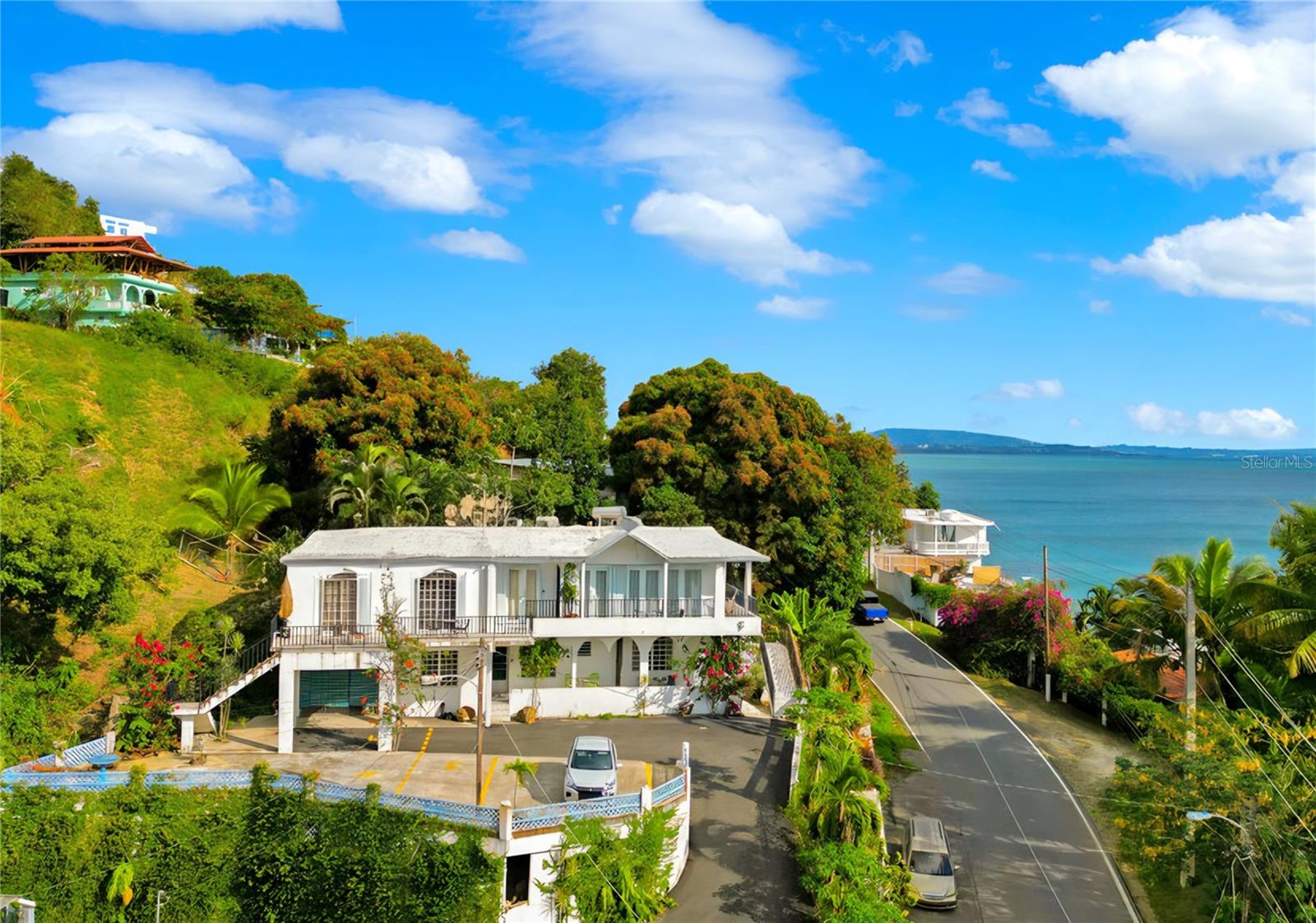 Exceptional multi-unit property featuring four spacious units plus a detached studio totaling five income-producing units.  There is even space for a sixth unit with a little TLC.  Ideally perched on the hill across the street from the sea, this property boasts beautiful ocean views, unique architectural details and lush, well-maintained landscaping.

Each unit offers generous layouts and is ready to go, making this an ideal turnkey investment or value-add opportunity. The property is well equipped with a generator, cistern, and ample storage throughout, ensuring convenience and reliability.

With its prime coastal location, flexible configuration, and endless possibilities, this is a rare chance to own a versatile seaside asset with strong upside potential.

Qualified buyers call for a viewing today!