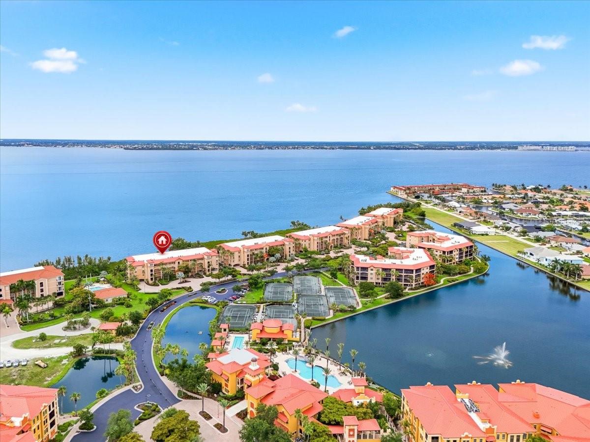 PEACEFULNESS MEETS LUXURY IN THIS WATERFRONT CONDO WITH SPECTACULAR HARBOR VIEWS! Own a beautiful harbor front home in a tranquil resort style gated community. Located in Vivante at Punta Gorda Isles, this end unit seamlessly blends indoor comfort with outdoor beauty. Expansive views of Charlotte Harbor greet you as you step off the private elevator into 2,398 square feet of recently remodeled open concept living space boasting a bright, airy atmosphere. Large windows and sliding glass doors showcase stunning scenery from nearly every angle. Wake up to soothing water views and enjoy watching wildlife and sailboats throughout the unit or from your elevated 280 square foot private screened lanai, the perfect spot to unwind with a sunset drink.

This 3 bedroom, 2.5 bath home is designed for comfort and elegance with an open floor plan, gourmet kitchen, and split bedroom layout. The expansive living and dining areas are perfect for entertaining. The chef's kitchen boasts stainless steel appliances, a powered center island, generous granite countertops, wood cabinetry, a tile backsplash, a large pantry, and a breakfast bar. The enormous primary suite is a true sanctuary with walk out access to the lanai, remote controlled blinds, a custom walk-in closet, and an en suite bath featuring an oversized shower and dual sinks. The split floor plan ensures guest privacy with two additional bedrooms featuring water views and large walk in closets. The laundry room offers a full sized washer and dryer with extra storage. One deeded parking spot is located steps from the elevator, with a secure storage space also located on the parking level.

Interior updates include a brand new Trane HVAC system with a WiFi thermostat installed in March 2026, durable commercial grade flooring, fresh neutral paint, and all new light fixtures, fans, switches, and outlets. The screened lanai features remote controlled Kevlar storm shades with a manual backup crank, providing effortless shade and protection.

This resort style community offers lush tropical landscaping, walking paths, and a 12,000 square foot clubhouse just steps away. Amenities include a heated pool, lap pool, hot tub, fitness center, 6 lighted Har Tru tennis courts, saunas, game rooms, a library, and an on site full service spa. Vivante is a lively community offering planned activities like fitness classes, game nights, and visiting food trucks. Location is convenient to airports, the newly expanded Fisherman’s Village, historic downtown Punta Gorda, marinas, parks, and golf courses. Enjoy a vibrant food, art, and music scene, world class boating, and fishing. A turn key option is available. Do not miss this one of a kind luxury Florida lifestyle. Schedule your showing today to claim your piece of paradise.