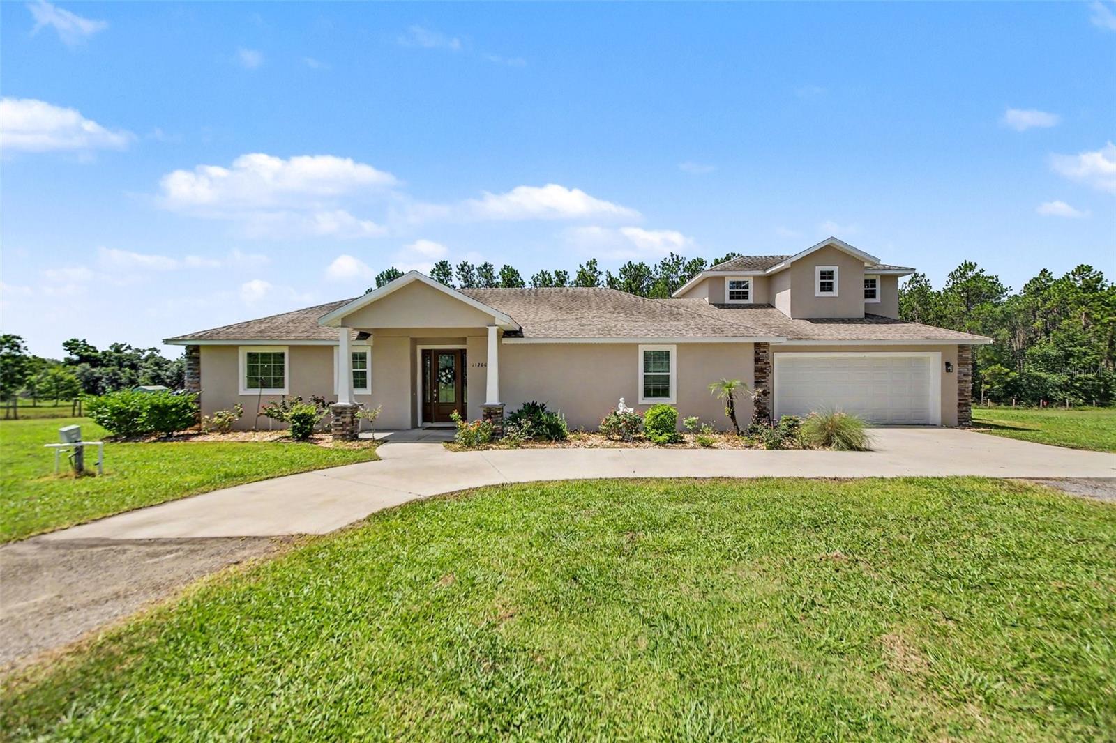 COUNTRY LIVING ON 5 ACRES WITH A POOL & NO HOA! Country living with city convenience! This 4-bedroom, 3.5-bath pool home sits on 5 fully fenced acres with NO HOA and is zoned AG. The open floor plan features vaulted ceilings, 8-foot doors, a dual-sided gas fireplace, and two primary suites. The kitchen offers stainless steel appliances, granite countertops, a walk-in pantry, and breakfast bar. Upstairs includes two bedrooms and a full bath. The main primary suite features tray ceilings, a fireplace, two walk-in closets, dual vanities, a walk-in shower, and a freestanding garden tub. Outside, enjoy the pool and a 30x50 steel-framed workshop with concrete floors and dual roll-up doors, perfect for storage, vehicles, hobbies, or a home business. Property includes 1 well and 2 septic systems. Bring your horses, cattle, and toys—this versatile property offers endless possibilities!