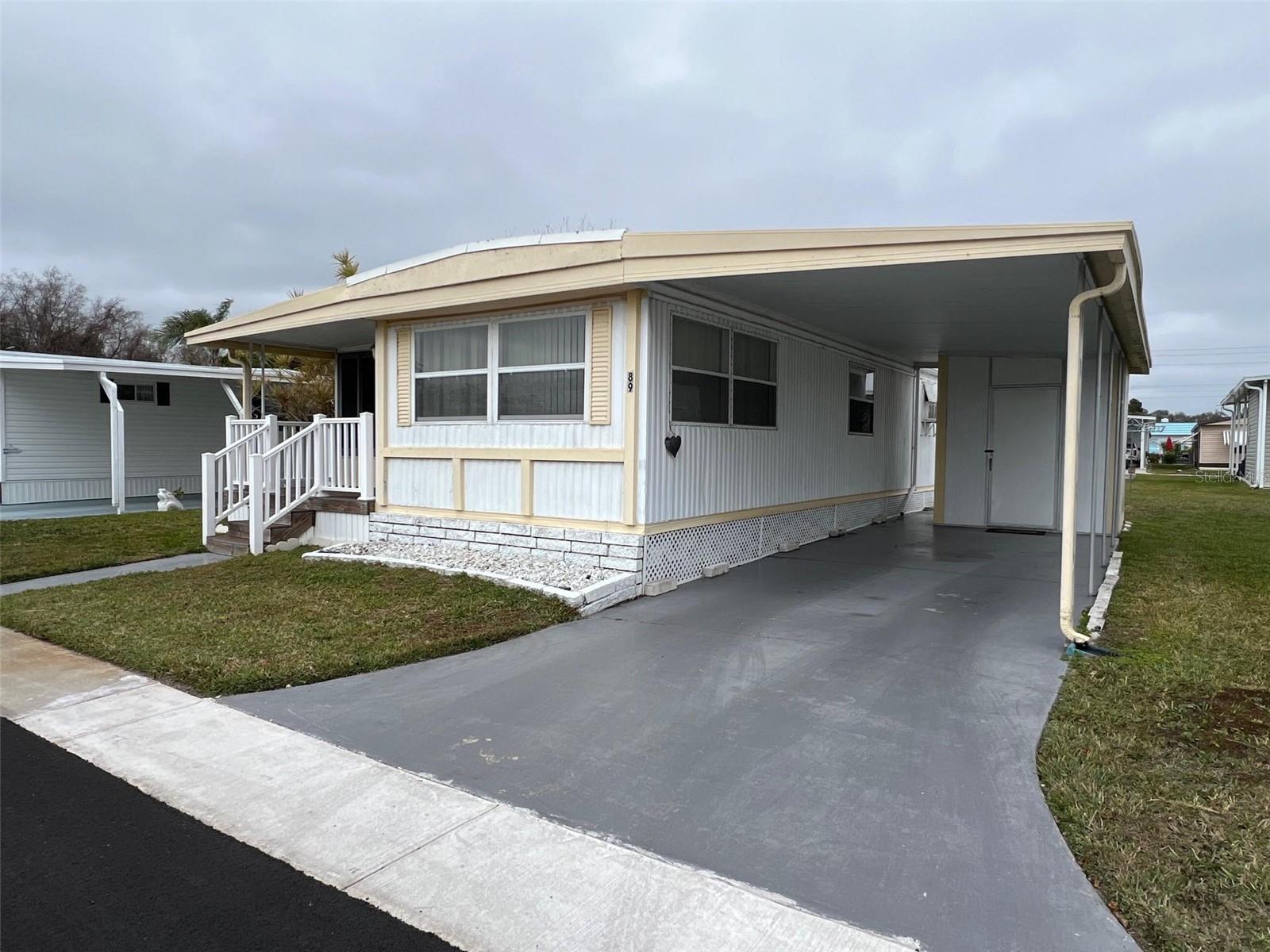 NEW LOWER PRICE! Step into a location where easy living and friendly faces set the tone from day one! Bel Aire Mobile Village is a pleasurable 55+ community known for its well-kept, bright, and cheerful atmosphere. Residents enjoy a wonderful selection of amenities, including a sparkling swimming pool, shuffleboard courts, an active clubhouse, and flexible recreational spaces. The community features well-maintained sidewalks that provide residents with a safe way to walk through the neighborhood and connect with their neighbors. With one of Pinellas County’s lowest maintenance fees—just $235.00 per month covering water, sewer, garbage, and lawn care—day-to-day living stays refreshingly uncomplicated. This new listing offers 2 bedrooms and 1 bathroom, ideal for a sunny seasonal retreat or a comfortable full-time residence. Best of all, one small pet is welcome to share in your wonderful new lifestyle!
INTERIOR:
Open the door to this charming home, and you’ll immediately notice how immaculately maintained and truly move-in ready it is. Offered fully furnished, the home features mostly updated windows, fashionable window blinds, ceiling fans, and laminate flooring throughout most of the space, while being accentuated by paneled walls finished in a refined, light color scheme. A delightful Florida room creates an inviting spot for easy entertainment, complete with attractive furnishings, tile flooring, and a window A/C unit. The eat-in kitchen features vinyl flooring, white cabinetry with plentiful storage, a stylish tile backsplash, and a full appliance package including a refrigerator, range, oven, microwave, and dishwasher, with a large window that fills the room with natural light. The splendid living room feels both open and welcoming—cozy enough for conversation yet spacious enough for gatherings. The pristine bathroom offers a long vanity with generous cabinet space for toiletries, accessories, and linens, vinyl flooring, and a step-in shower accessible to all. The guest bedroom includes built-in drawers, a cupboard, and a sizable closet, making it ideal for visitors, while the primary bedroom is impressive in size and storage, featuring built-in drawers, a cupboard, and an ample closet to keep everything neatly organized.
EXTERIOR:
This well-maintained home catches the eye with its inviting exterior and a pleasing front porch that's a perfect spot to rock the day away! Practical features include a two-car carport and a roof-over added in 2012, plus a versatile shed for storing yard equipment, bicycles, and other items. Priced attractively at $72,900 (with a share included), this property offers excellent value and eye-catching curb appeal.  Fresh, functional, and highly appealing—schedule your private showing sooner rather than later!