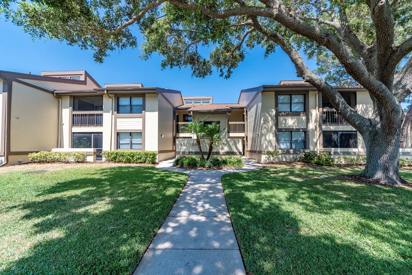 REDUCED 20,000 FROM ORIGINAL LISTING PRICE!! If you’re looking for a beautiful waterfront location and an exceptional condominium, this scenic Lakefront residence in Woodlake Run at East Lake Woodlands is the perfect fit. Set within a gated, very well-maintained community, the condo offers outstanding curb appeal, tranquil water views, mature landscaping, and a peaceful natural setting that defines one of Pinellas County’s most desirable areas Just steps from the front door, the heated pool provides year-round enjoyment and adds to the effortless lifestyle this property delivers. Inside, the comfortable living area features soaring ceilings and opens to a screened-in lanai overlooking the lake, The adorable kitchen includes shaker-style wood cabinetry and granite countertops, with the dining area conveniently positioned just off the kitchen for easy everyday living and entertaining. The spacious primary bedroom showcases gorgeous water views, brand-new 2026 carpet, and a generously sized walk-in closet. Major improvements include a 2023 A/C system, new 2026 water heater, a 2022 electrical panel, and a full-size washer and dryer. The owner is leaving everything with the unit, including a new leather sofa, leather accent chair, king-size bedroom set, Smart TV, linens, kitchen utensils, décor, artwork, and all household items, making this a true turnkey opportunity. The maintenance-free lifestyle is impressively comprehensive and very reasonable, covering the heated pool, exterior maintenance, roof, internet, cable, water, sewer, pest control, waste services, grounds maintenance, and gated entry. East Lake Woodlands is known for its scenic surroundings, two golf courses, and optional country club, tennis, and swimming amenities. The location is ideal, close to shopping, dining, and outdoor recreation, approximately fifteen minutes to Honeymoon Island State Park for stunning beaches and Gulf sunsets, and about thirty minutes to Tampa International Airport for convenient travel. The property is also located in a no-flood zone. Whether you’re seeking a primary residence, seasonal retreat, or investment property, this waterfront condo offers outstanding value in a highly sought-after community and is priced below the comparable sales.