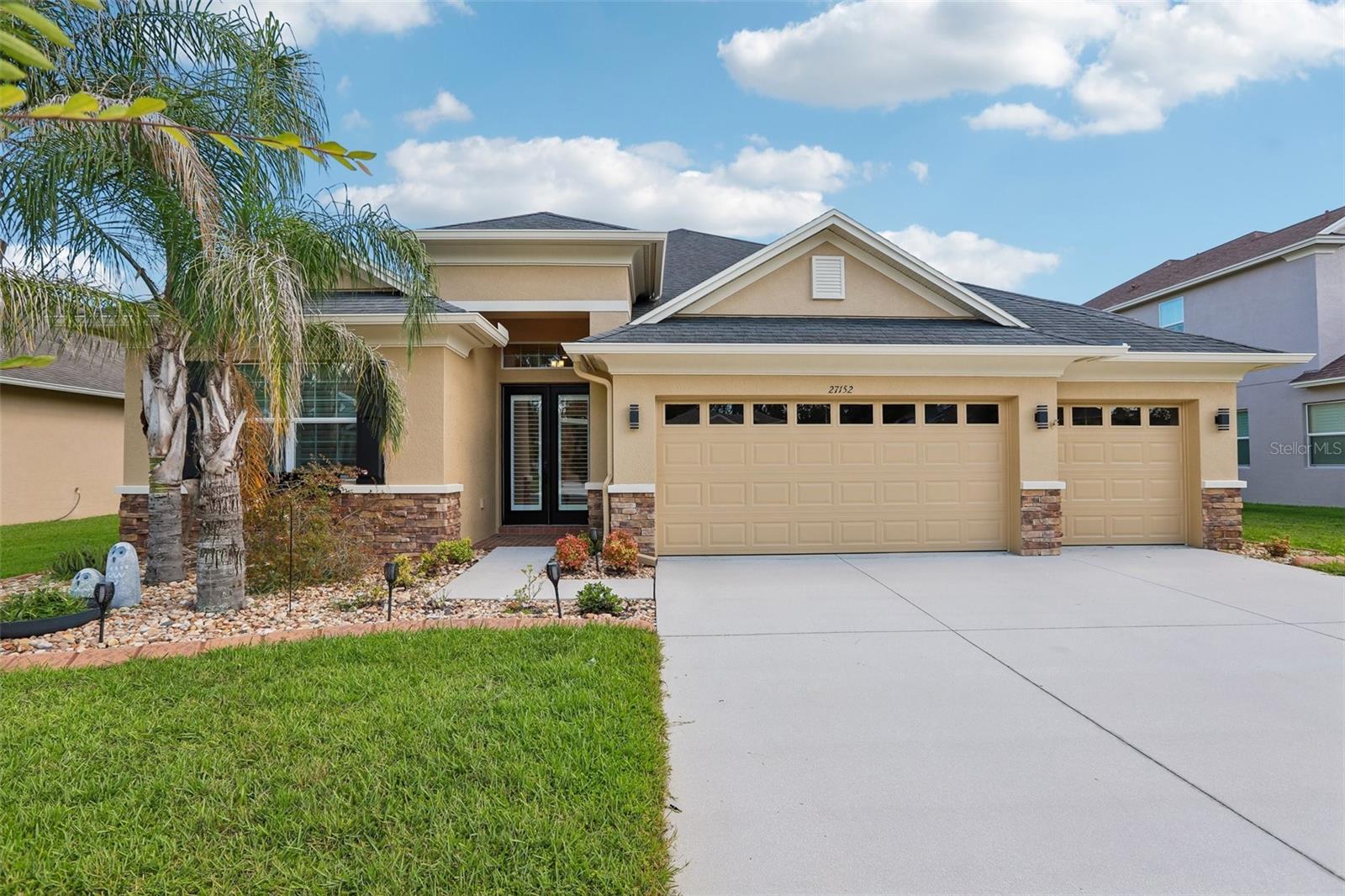 Virtually Staged. Rarely does a home of this price offer this combination of gated privacy, breathtaking pond views, and an exceptionally versatile floor plan featuring 4 Bedrooms + Office + Bonus + 3 Car Garage - From the oversized saltwater pool and spa to the massive upstairs bonus room with a private balcony overlooking the water, this home is anything but ordinary - and all with NO CDD Fees and a very low HOA!! Tucked behind the gates of Quail Woods in Wesley Chapel, FL, this exceptional executive home, built in 2016 by Southern Crafted with attractive stacked stone accents is one of the newest homes in the community, and has been beautifully refreshed with fresh interior and exterior paint and brand-new carpet in all bedrooms and the expansive upstairs bonus room.
Step inside to discover an inviting open-concept design enhanced by plantation shutters, rich wood flooring in the living room and primary suite, soaring tray ceilings, graceful arched doorways, and elegant art niches. Triple sliding glass doors seamlessly connect the main living space to the oversized screened lanai, where a spectacular pool and spa create the perfect backdrop for relaxing while enjoying tranquil water views.
The well-appointed kitchen is truly the heart of the home, featuring warm 42-inch wood cabinetry with crown molding, a stylish tile backsplash, a large center island with additional storage, and a wraparound breakfast bar illuminated by pendant lighting—ideal for gathering with family and friends.
The private primary retreat offers a luxurious escape with dual walk-in closets and a spa-inspired en suite bathroom complete with split vanities, a relaxing garden tub, and an oversized walk-in shower with dual shower heads. A dedicated home office provides the perfect space for remote work or study.
Upstairs, a massive bonus room with a dramatic vaulted ceiling opens to a private balcony overlooking the lanai and pool below, creating endless possibilities for a media room, game room, or additional living space. An upstairs bedroom with its own en suite bath offers comfortable accommodations for guests or multigenerational living.
Offering an outstanding combination of refined finishes, versatile living spaces, and a beautiful waterfront setting within one of Wesley Chapel's desirable gated communities, this remarkable residence is ready to welcome you home. All just minutes from vibrant retail shopping, restaurants, hospitals, entertainment, and all the amenities of the booming Pasco County corridor!