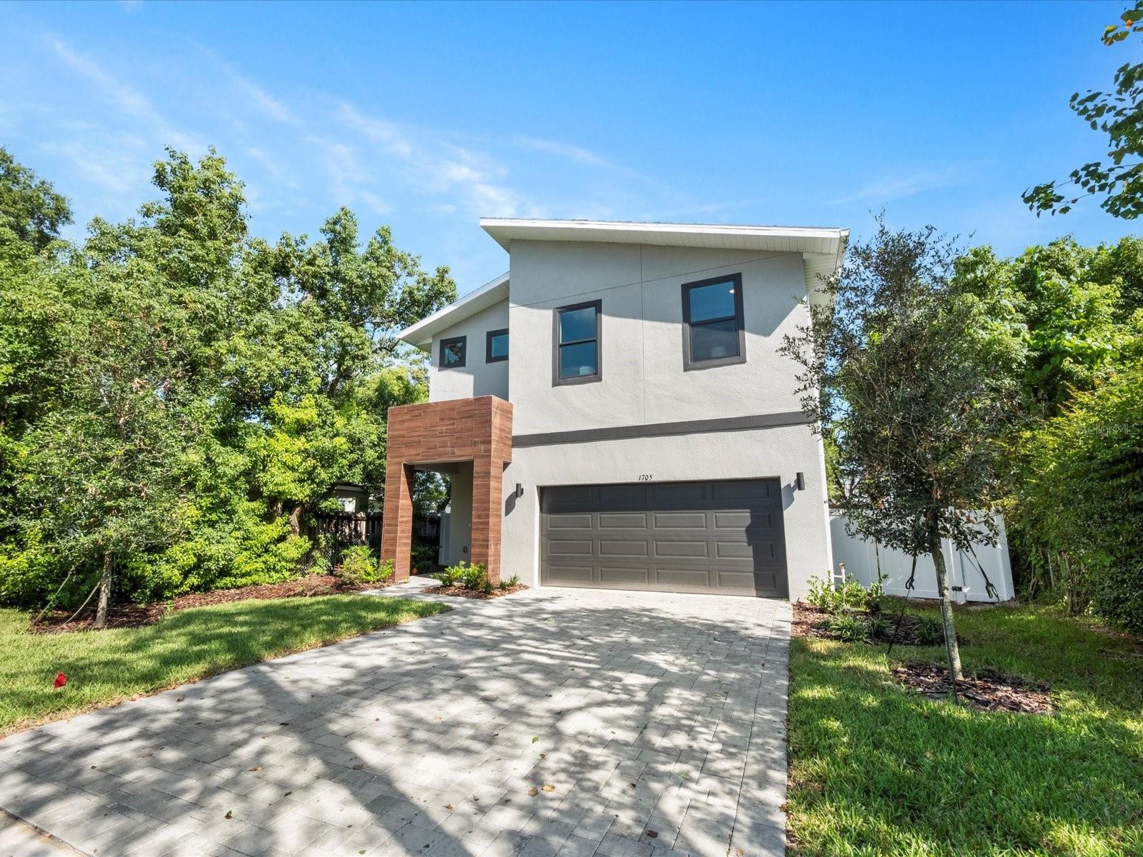 **Builder to provide dramatically lower interest rate for well qualified buyers!** You will love this modern home nestled in one of the most desirable neighborhoods of Winter Park. Sandwiched between Dubsdread golf course, the Mills/50 district, Fairbanks Ave, and College Park, this location simply can't be beaten. Walkable dining and shopping options abound, with short drives to some of Orlando's best regions and restaurants, like those on Park Ave. It's also just a few short blocks from I-4 and other convenient roads. Furthermore, just drive one block in any direction to see other new homes popping up, signaling a trend in this established neighborhood. Just as good as the location is the home itself, with its modern facade, including a faux wood-accented entranceway, 2-car garage, and fenced-in yard. 

As you enter the home and pass the upgraded stairwell with a modern railing, you'll notice the conveniently located half bath and the "Harry Potter" storage room under the stairs. Then, you'll enter into the massive great room concept, lit up by the natural light pouring in. The wood-look tile adds warmth to an already inviting space, while the bold light fixtures and high ceilings add that modern touch. The kitchen is the focal point of the space, flanked by a perfectly sized open dining area surrounded by windows. The kitchen boasts modern white quartz countertops, two-toned cabinets with modern hardware, huge walk-in pantry with storage system, vent-to-exterior range hood, a barn sink, and a large island that perfectly ties the great room together. Entering the space from the 2-car garage is extra convenient with a thoughtfully designed mudroom featuring bench seating, shoe storage, upper cabinets, and hanging hooks.

As you ascend the upgraded stairs with no carpet, you'll notice the engineered wood floors continue past the large laundry and into the huge master suite. More natural light greets you as you marvel at the size of your new bedroom. Peek into the cavernous walk-in closet and imagine the possibilities implied by the amazing closet system. Furthermore, the master bathroom, with a modern free-standing tub, separate shower stall, bold tile choices, dual vanities, and yes, more natural light, really pushes the suite over the top. The additional three bedrooms and guest bath are also upstairs. Bonus features include a large covered patio, 10-year home warranty, an irrigation system, and a paver driveway.