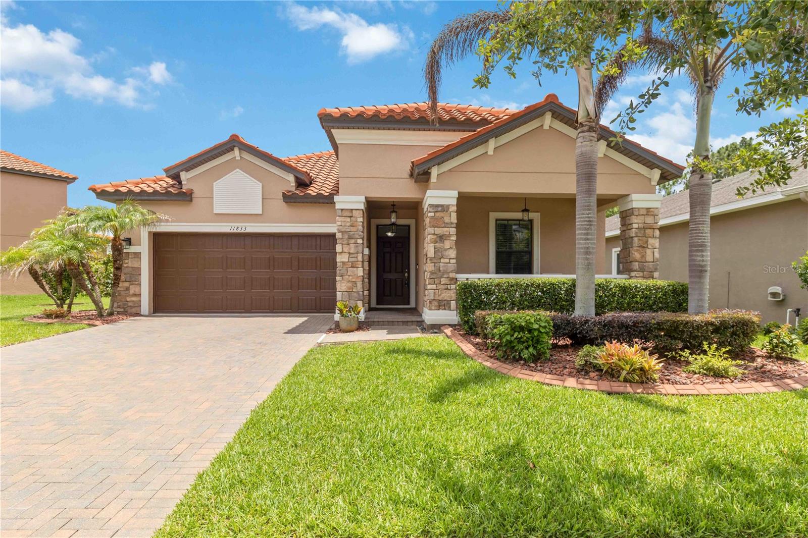 One or more photo(s) has been virtually staged. Welcome to Waterleaf, a sought-after gated community offering amenities and beautiful surroundings. This well maintained Mediterranean-inspired single-story home is situated on a private preserve lot, featuring mature tropical landscape/edging/irrigation, a spacious paver driveway, and two inviting covered porches (front/back). The screened lanai, fenced backyard, preserve setting, and expansive side yard provide privacy and outdoor living space. Upon entering, you'll appreciate the elegant tray ceilings, 9-foot ceilings, ceramic tile floor, and exquisite crown molding. Designed with both comfort and functionality in mind, this home offers a desirable split-bedroom floor plan with 4 bedrooms, 3 full bathrooms, and an open-concept layout ideal for everyday living and entertaining. The spacious kitchen serves as the heart of the home, featuring a large center island, beautiful espresso 42" cabinets with pull-out shelving, granite, tile backsplash, updated glass pendant lighting, deep SS sink, and SS appliances, including refrigerator (new 2025). Located at the rear of the home, the primary suite showcases a tray ceiling, ceiling fan, tile floors, and a luxurious en-suite bath w/ a generous walk-in closet (which also houses smart home access). Conveniently connected to both the owner's suite and kitchen is the updated laundry, featuring custom white cabinetry specially ordered to match the kitchen (2021–2022), custom oak shelf, and add'l storage. At the front of the home, two generously sized bedrooms share a well-appointed full bathroom with dual sinks. The fourth bedroom and third full bathroom are situated near the garage entrance, offering excellent flexibility for guests, office, or multigenerational living. This area also includes matching custom cabinetry and granite countertop. Additional highlights include original tile roof (2015), HVAC (2025 w/ 12 year transferable warranty), water heater (2025), roof professionally cleaned (2025), refrigerator (2025), and washer/dryer/water softener (newer). The kitchen is equipped with a reverse osmosis water filtration system. Int/ext paint (2025-2026). Garage storage is abundant, including pull-down attic ladder.
See highlight sheet. Photos include AI generated pics, listing agent is also seller.