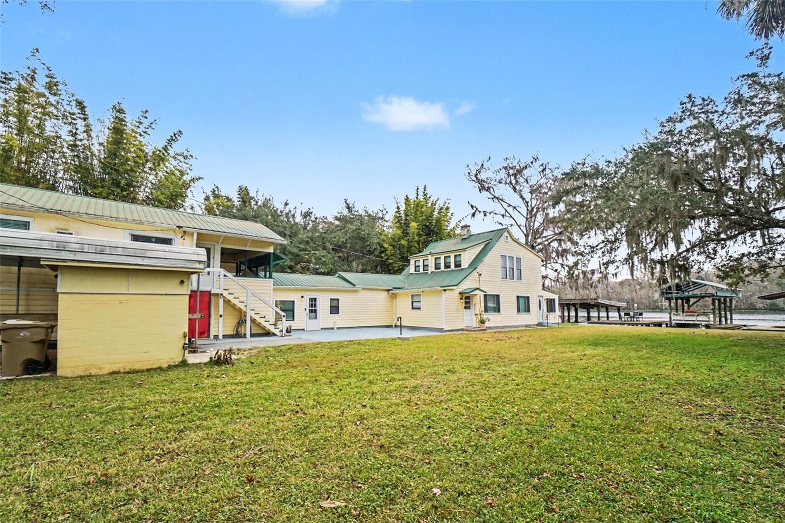 DIRECT ST. JOHNS RIVER FRONTAGE WITH PRIVATE DOCK, SEAWALL, BOATHOUSE, AND DEEP-WATER NAVIGABLE ACCESS — this rare 1910 WATERFRONT HOME in HISTORIC ASTOR offers 4 BEDROOMS, 4 BATHS, OLD FLORIDA CHARACTER, and exceptional long-term waterfront value.

Located at 55316 CLAIRE STREET in the heart of ASTOR, FLORIDA, this WATERFRONT SINGLE-FAMILY RESIDENCE sits directly on the ST. JOHNS RIVER, offering NAVIGABLE WATER ACCESS, an UPDATED PRIVATE DOCK, CONCRETE SEAWALL, and BOATHOUSE — features that are increasingly difficult to find at this price point. Built in 1910 and thoughtfully expanded over time, with an effective year of 1995, the home offers 2,714 TOTAL SQUARE FEET of living space across 4 BEDROOMS AND 4 BATHROOMS, blending OLD FLORIDA CHARM with functional modern living.

The property sits on an approximately 0.19–0.20 ACRE WATERFRONT LOT, approximately ±8,500 SQ FT, with WEST-FACING FRONT EXPOSURE and unobstructed river views that capture stunning sunsets, wildlife activity, and year-round boating enjoyment. The MAIN HOME features 3 BEDROOMS AND 3 BATHS, including a FIRST-FLOOR PRIMARY BEDROOM, formal living and dining rooms, a WOOD-BURNING FIREPLACE, and expansive windows overlooking the river. Above the 2-CAR GARAGE, an ATTACHED 1-BEDROOM / 1-BATH APARTMENT WITH PRIVATE ENTRANCE provides excellent flexibility for MULTI-GENERATIONAL LIVING, GUEST SUITE USE, OR RENTAL INCOME. The apartment is currently tenant-occupied.

Interior finishes include ENGINEERED HARDWOOD FLOORING, SOLID WOOD CABINETRY, UPDATED KITCHENS WITH GRANITE COUNTERTOPS, and refreshed lighting throughout the living areas. Major systems have also been addressed, including UPDATED HVAC, UPDATED WATER HEATER, and durable METAL ROOFING — a key advantage for longevity and insurance considerations. The property is located in FEMA FLOOD ZONE AE, with mitigation steps already taken.

Outside, the riverfront setting is the true differentiator. Enjoy DIRECT DEEP-WATER ACCESS, private dockage, boating, fishing, kayaking, and easy travel north toward PALATKA or south toward DELAND and the wider ST. JOHNS WATERWAY SYSTEM. ASTOR carries deep Florida history, once serving as a hub for STEAMBOAT TRADE AND TIMBER TRANSPORT in the late 1800s. Today, it remains known for its OLD FLORIDA RIVER TOWN CHARM, OUTDOOR RECREATION, and undeveloped natural surroundings — offering the slower pace many buyers are now seeking outside more congested markets.

This is a UNIQUE WATERFRONT OPPORTUNITY for buyers seeking RIVER ACCESS, PRIVATE DOCKAGE, A BOATHOUSE, SEAWALL, CHARACTER, FLEXIBLE LIVING SPACE, AND LONG-TERM VALUE. DIRECT ST. JOHNS RIVER FRONTAGE WITH PRIVATE DOCK, SEAWALL, BOATHOUSE, NAVIGABLE WATER ACCESS, 4 BEDROOMS, 4 BATHS, AND A RARE HISTORIC ASTOR WATERFRONT SETTING.