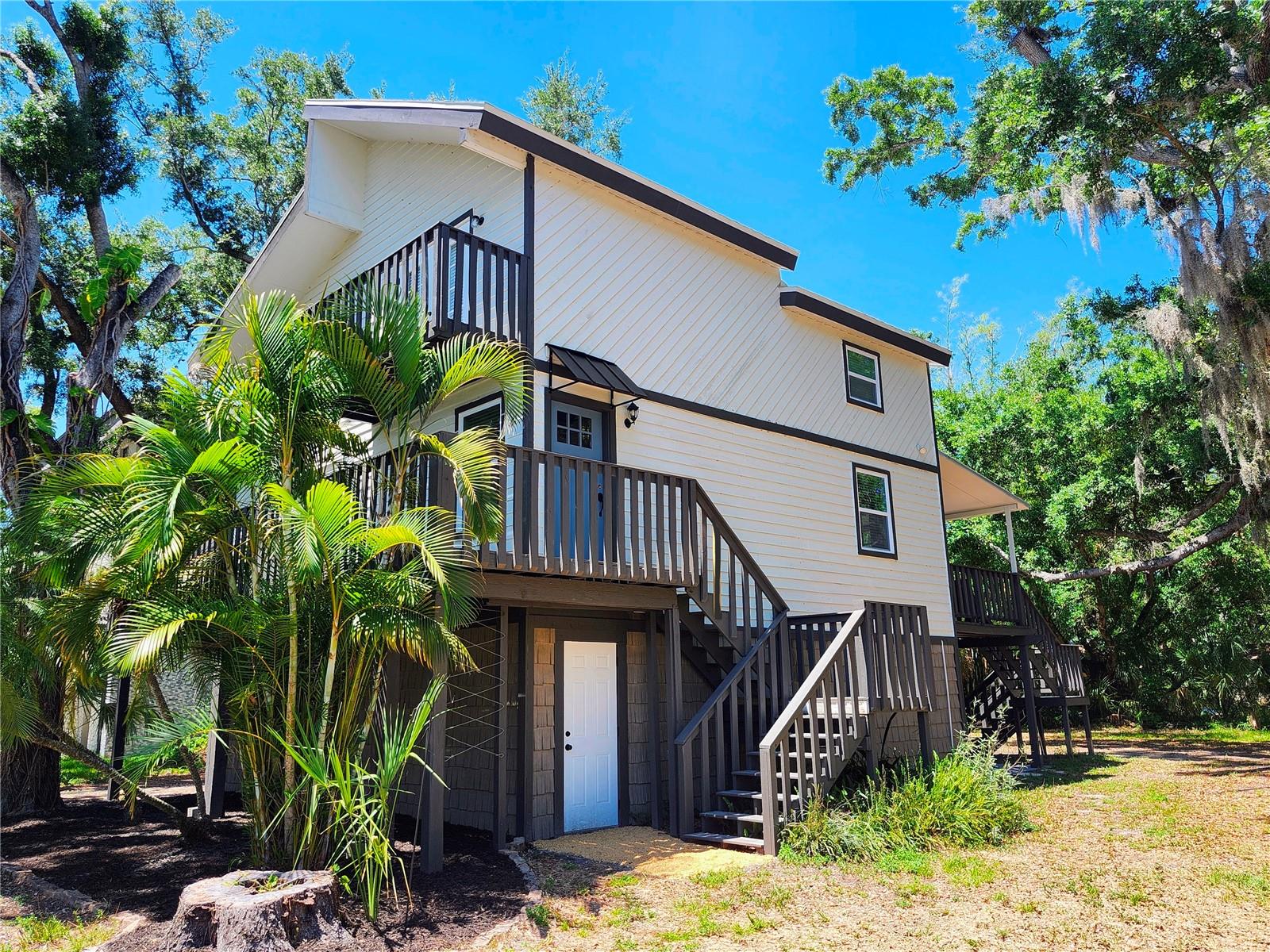 OWNER FINANCING! Come see this amazing home in one of Oldsmar's best kept secret neighborhoods on the sparkling shores of Old Tampa Bay! This 3-bedroom, 2.5-bath multi-level designed home blends coastal charm with modern updates. Above the Oversized 2-car garage and upon entering inside, get ready to be impressed by the high ceilings, all NEW WINDOWS, DOORS & light filled living spaces amongst the refinished oak hardwood & gorgeous porcelain ceramic tile flooring throughout. NEW ROOF 2024! STAIRS & DECKS REFURBISHED! The STUNNING KITCHEN has QUARTZ countertops & stainless steel appliances opening into the living and grand dining rooms with french doors onto the enormous covered deck. It's perfect for entertaining and family time. Upstairs you find 3 good sized bedrooms and 2 full bathrooms. The primary suite features french doors to its own private balcony along with a spa inspired ensuite bathroom featuring a luxurious freestanding tub & separate shower that feels straight from a boutique retreat. Not only is this home perfect for all your year round outdoor activities, you can even cozy up by the wood burning fireplace during cold times. The 2 car garage offers exceptional storage space for all the extras, while the oversized back yard opens the door to endless possibilities to make it your new tropical paradise with room for a pool, gardens, boat or RV parking, and even a potential in-law suite. Just minutes from several Waterfront Parks (R.E. Olds Park is biking distance), Scenic trails, Boat ramps, Fishing, Tennis, Pickle ball, Golfing, Tampa Bay Downs, Shopping, Restaurants, and Top Rated Schools in this location, you truly have it all!