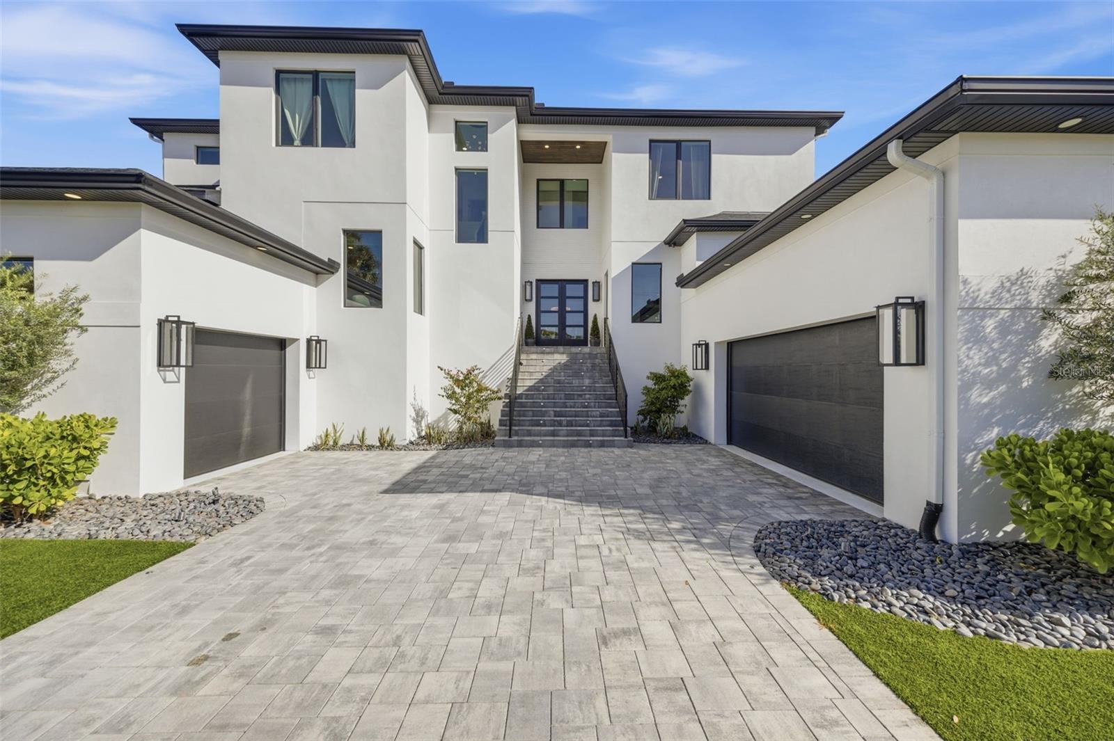 Welcome to Sunset Park's ultimate statement home where you experience 5,288 square feet of refined luxury in the heart of South Tampa. This one-of-a-kind custom home is only two years old, giving you confidence in the home as it has been lived in and loved on with meticulous care. The gorgeous home sits on an expansive 88’ x 140’ double lot surrounded by other newly constructed residences and is truly a showstopper. Designed with both style and comfort in mind, this home defines luxury living and offers abundant space for entertaining and everyday enjoyment. This exceptional residence showcases an expansive open-concept kitchen and great room accented by elegant coffered ceilings and featuring all premium Viking appliances. Custom all-wood cabinetry with soft-close drawers and hand-finished doors is complemented by premium quartz countertops throughout. Additional highlights include a spacious walk-in pantry with custom wood shelving and sink prep area, a glass-enclosed, climate-controlled wine room—perfect for show-stopping conversations. Luxury details abound, including wide-plank, hand-scraped natural wood flooring, 8’ solid-core doors, impact-rated windows and doors, decorative millwork with wainscoting, and a private elevator. The home is filled with the high-end amenities today’s discerning buyer seeks, including a decadent bar for the entertainer and dual laundry rooms on each floor for maximum convenience—this home truly has it all. The private owner’s retreat, which is located downstairs, offers oversized custom walk-in closets and a spa-inspired bathroom complete with a walk-through shower, freestanding soaking tub, and state-of-the-art Moen fixtures, including the Moen U digital shower system with LCD control. Designed for both entertaining and everyday living, the home also features a 400+ square foot media/game/flex room. Four-panel, 12’ pocketing sliding doors seamlessly connect the interior to a true Florida outdoor living experience, showcasing an oversized lanai with stone decking, a beautifully finished wood ceiling, a full outdoor kitchen with a large seating bar area, and a custom pool with spa and cascading waterfall. Additional features include a whole-home generator, alarm system, smooth drywall finish, 3 car garage, and Smart Home readiness with numerous included features. Contact me today for your private tour of 4815 Sunset Blvd.