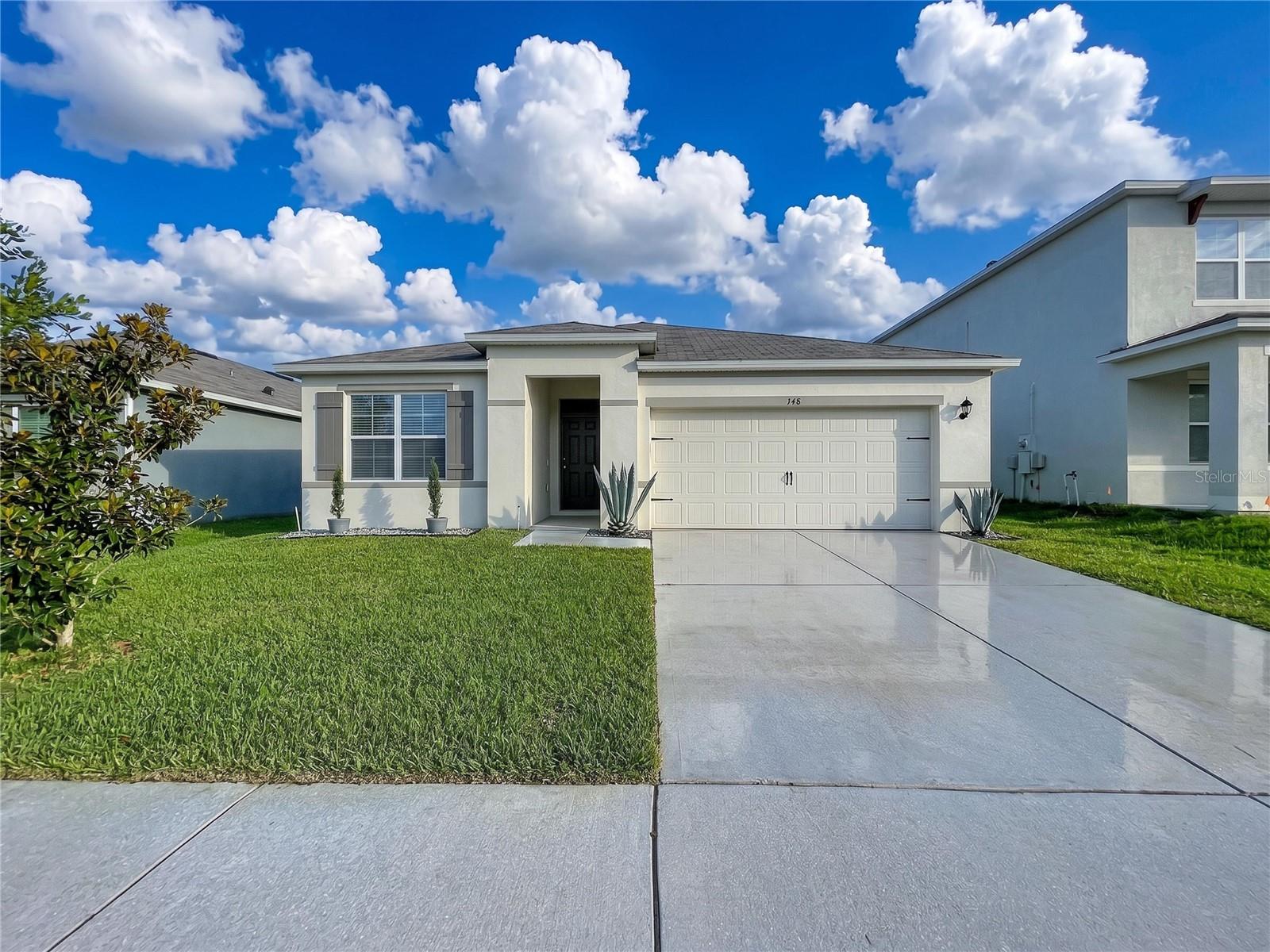 Welcome to 148 Ludisia Loop in Davenport, Florida! This move-in ready home offers a well-designed floor plan with stylish finishes and comfortable living spaces throughout. The kitchen features beautiful granite countertops, ample cabinetry, and a functional layout perfect for everyday living and entertaining. Tile flooring flows through the common areas and bathrooms, offering durability and easy maintenance. The bathrooms also feature granite countertops, adding a consistent upgraded touch. Enjoy Florida living from the screened-in lanai overlooking the fenced rear yard, ideal for relaxing, entertaining, pets, or play. The community offers desirable amenities including a pool, clubhouse, park, and sidewalks, creating a welcoming neighborhood atmosphere. Conveniently located near shopping, dining, major roadways, and Central Florida attractions, this home is ready for its next owner!