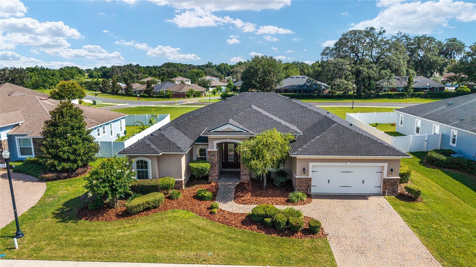 **Deltona-Built Preserve at Heath Brook Home | Roof 2025 | HVAC 2026 | Minutes to WEC, Hospitals & I-75**

Welcome to the "House on the Hill," a beautifully customized residence located within the highly sought-after Preserve at Heath Brook, one of Ocala's premier communities known for its natural surroundings, walking trails, convenience, and exceptional location.

Perfectly positioned atop a scenic rise, this home captures beautiful Central Florida sunsets and peaceful preserve views while offering the rare combination of privacy, accessibility, and everyday convenience. Surrounded by mature landscaping and natural green space, residents enjoy a tranquil setting with walking paths, preserved natural areas, and a neighborhood designed for those who appreciate both nature and community.

Built by Deltona, a builder recognized for quality construction, thoughtful floor plans, and architectural detail, the home showcases numerous upgrades and custom features throughout. Offering the flexibility today's buyers desire, the floor plan functions as either a 5-bedroom, 3-bath residence or a 4-bedroom, 3-bath home with a dedicated office/flex room featuring a custom Murphy bed—perfect for guests, multigenerational living, remote work, or a private study.

From the moment you arrive, elegant stone accents, paver details, and timeless curb appeal create an inviting first impression. Inside, warm wood flooring, custom millwork, wainscoting, architectural ceilings, and built-in features elevate the home's character and craftsmanship.

The spacious great room serves as the centerpiece of the home, featuring a stunning stone fireplace, custom built-ins, and an open-concept design that flows seamlessly into the kitchen and dining areas. Designed for both entertaining and everyday living, the upgraded kitchen features 42-inch cabinetry, granite countertops, a large center island, breakfast bar seating, abundant storage, and a charming breakfast nook complete with custom built-in bench seating.

The thoughtfully designed split-bedroom floor plan provides privacy for family and guests alike. Secondary bedrooms are generously sized and connected by a convenient Jack-and-Jill bathroom, while the spacious primary suite serves as a private retreat with dual walk-in closets and a well-appointed ensuite bathroom.

Outdoor living is equally impressive with an expansive screened lanai and oversized patio, creating the perfect setting for entertaining, grilling, relaxing, or enjoying Florida's year-round outdoor lifestyle.

For buyers relocating to Ocala, few locations offer greater accessibility. Situated just minutes from Interstate 75, the property is approximately 10 minutes to the World Equestrian Center, 10 minutes to the Florida Horse Park, and moments from Ocala's major medical facilities, the new VA Clinic, shopping, dining, entertainment, and top-rated schools. Whether you're an equestrian enthusiast, medical professional, remote worker, or simply seeking a better quality of life, this location places everything within easy reach.