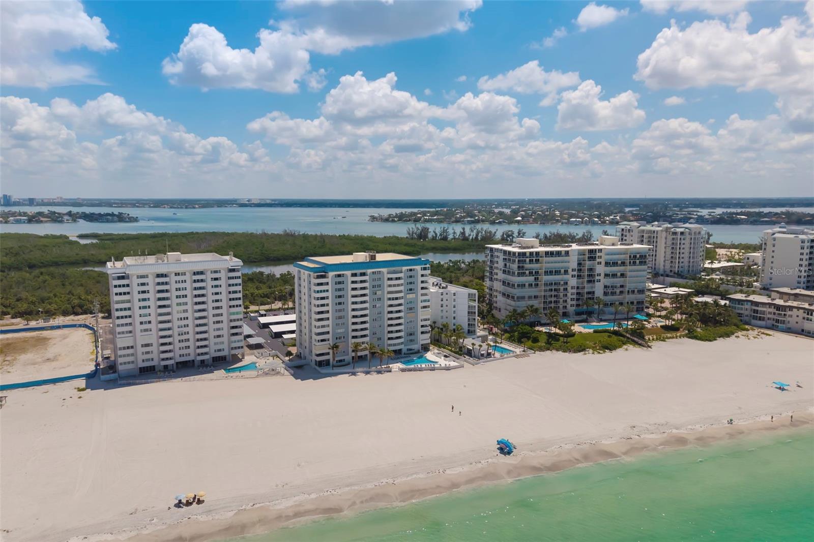 Virtually Staged. Experience Gulf-front living at its finest from one of Lido Key’s most desirable beachfront addresses. Perfectly positioned directly on the sugar-white sands of the Gulf of Mexico, this beautifully updated residence offers breathtaking access to the Gulf that truly feels like having your own private beach. This exceptional condominium presents a rare opportunity to begin enjoying the island lifestyle immediately, whether as a full-time residence or an elegant coastal retreat.  

Inside, the spacious floor plan offers over 2,000 square feet of thoughtfully designed living space filled with natural light. The expansive living and dining areas are perfectly positioned to capture spectacular views of the intercostal waterway, while the enclosed balcony extends to add even more space for morning coffee, evening cocktails, or simply watching the sunrise. A dedicated office provides the ideal space for working remotely, reading, or pursuing hobbies, adding flexibility rarely found in beachfront condominiums of this size. The well-appointed kitchen features solid wood cabinetry, granite countertops, dedicated desk, and an open design that keeps you connected to the surrounding living spaces.  

The spacious primary suite serves as a peaceful retreat complete with additional panoramic views, a walk-in closet, and private en-suite bath. The guest bedroom is thoughtfully positioned to provide comfort and privacy for family and visitors. Additional conveniences include a dedicated covered carport space and a private storage locker located within the shared laundry area, offering plenty of room for beach chairs, bicycles, and seasonal items.

Key Tower South is one of Lido Key’s premier beachfront communities, meticulously maintained and offering an outstanding collection of amenities. Residents enjoy a brand new heated Gulf-front swimming pool surrounded by an expansive sundeck, providing one of the area’s most impressive beachfront settings. The community has recently completed a full renovation of the first-floor common areas in 2025, featuring an elegant lobby, fitness center, library, social room with full kitchen, saunas, bicycle storage, on-site management, and direct beach access just steps from your door.  

Outside, discover why Lido Key is one of Sarasota’s most coveted coastal destinations. Enjoy peaceful, walkable streets with significantly less traffic than neighboring barrier islands, while remaining just minutes from world-famous St. Armands Circle, South Lido Park’s nature trails and kayak launches, Downtown Sarasota’s renowned dining, shopping, performing arts, and marina, all connected by the scenic Ringling Bridge. SRQ Airport is also just a short drive away, making travel exceptionally convenient.

Offering spectacular Gulf views, direct beachfront living, a beautifully updated interior, and one of Sarasota’s most desirable island locations, residence delivers the coastal lifestyle so many dream about. Schedule your private showing today and experience this exceptional Lido Key opportunity firsthand.