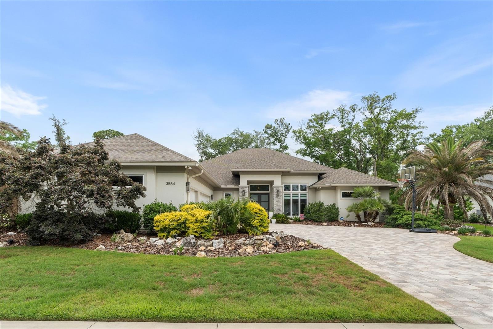 Perfectly positioned on a premium half-acre lot backing to peaceful green space, this stunning luxury home offers over 3,600 sq ft of thoughtfully designed living space with 4 bedrooms, 4.5 baths, a private study, and an oversized recreational/media room. Sophisticated architectural details, custom tray ceilings, modern lighting, sleek finishes, and abundant natural light create an elegant, contemporary feel throughout the home.  The private study features sliding barn doors and custom built bookshelves and cabinetry, while the recreational/media room flows seamlessly into the Florida room and outdoor living spaces. Designed for effortless indoor-outdoor living, the resort-style backyard showcases a sparkling pool with sun shelf and waterfall feature, shaded lounging areas, outdoor fireplace, and fully equipped summer kitchen—perfect for year-round entertaining! The chef’s kitchen is both beautiful and functional, featuring an oversized quartz island, stainless steel appliances, a modern, glass backsplash, oversized pantry, coffee bar, abundant storage, a wine/beverage refrigerator, and many other features! The luxurious owner’s retreat is special: dual custom closets, a frameless glass walk-in shower AND a six-foot freestanding soaking tub!  Additional highlights of the home include a paver driveway leading to the 3-car garage with EV charging station disconnects, remote-control shades, LED "Holiday Trim lights for pool and front of the home, a spacious laundry room with stone countertops and exceptional storage throughout. Blending modern elegance, comfort, and craftsmanship, this remarkable home offers the lifestyle you have been waiting for in one of the most desirable communities in Gainesville!  Close to UF, UF Health, North Florida/HCA, the conveniences and walking trails of the Haile Village, with the serenity of a luxurious retreat!