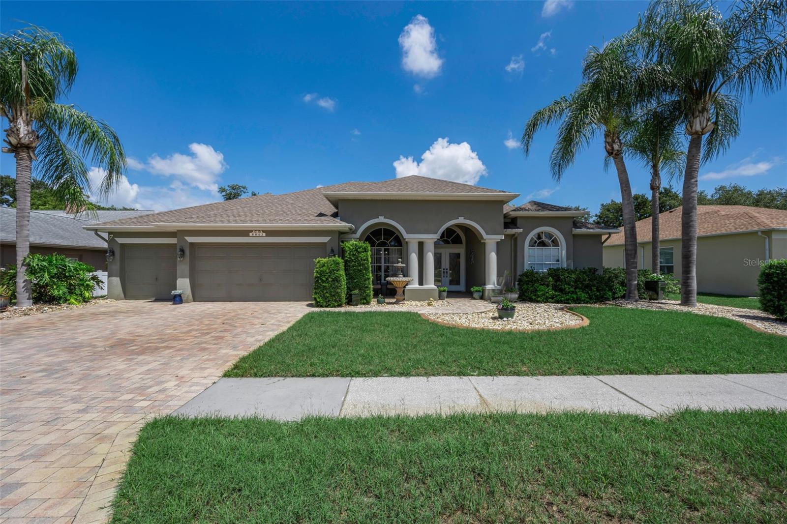 Welcome to this spectacular home located in this desirable gated community of The Villages of Fox Hollow ''Bellreive'' in Trinity!  Experience refined Florida living in this exceptional 5-bedroom, 3-bath home with a 3-car garage, nestled within a desirable gated community. Designed with both elegance and functionality in mind, this beautifully maintained home features an expansive three-way split floor plan, offering the perfect balance of privacy and open-concept living. At the heart of the home, the chef-inspired kitchen boasts abundant cabinetry, extensive counter space, and generous storage, seamlessly flowing into the spacious family room highlighted by a warm, inviting fireplace. The thoughtfully designed layout is ideal for both everyday living and effortless entertaining. Step outside to your own private oasis, where a screened-in pool and fully equipped outdoor kitchen create the ultimate setting for year-round enjoyment. With no rear neighbors, you’ll appreciate the added tranquility and privacy this exceptional homesite provides. Additional highlights include a new roof (2018), water softener (2018), and water heater (2022), offering peace of mind for years to come. Combining timeless style, generous living spaces, and premium outdoor amenities, this remarkable home is a rare opportunity to enjoy luxury, comfort, and privacy in one stunning package.