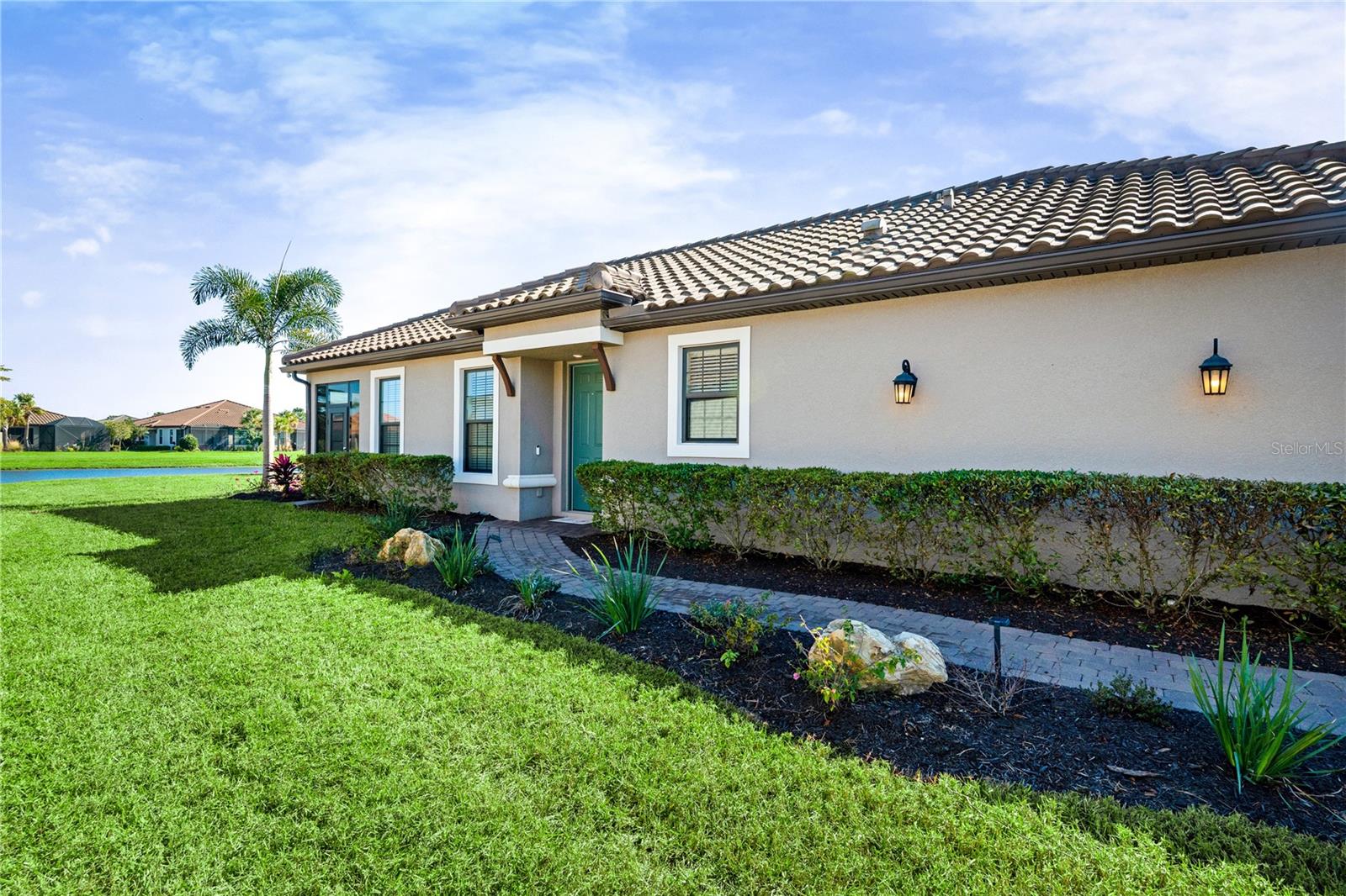 Welcome to this exceptional deeded golf home in the gated Azario community, Enjoy Lock-and-Leave Luxury, Resort Lifestyle, & Waterview.
Perfect as a second home or seasonal retreat, offering just under 1,700 square feet of thoughtfully designed living space and over $125,000 in upgrades. Situated on an extra-large premium waterview lot, this 2-bedroom, 2-bath residence also features a den/office, separate living and dining areas, and an open floor plan ideal for both everyday living and entertaining.
The spacious kitchen showcases quartz countertops, soft-close cabinets and drawers, a built-out California Closets pantry, and abundant workspace. All-tile flooring, crown molding, pocket doors, and expansive three-panel sliding glass doors fill the home with natural light and create a seamless indoor-outdoor flow.
Step onto the east-facing lanai and enjoy serene water views, a fully equipped outdoor kitchen, removable Eze-Breeze panels for year-round comfort, and plenty of space to add a large pool and expanded outdoor living area.
Additional upgrades include Category 5 impact windows and lanai doors, custom California Closets in two rooms, blinds on all windows, designer fans, garden landscaping and lighting, gutters, and a custom laundry room with sink. The extended 4-foot garage features an epoxy floor, overhead storage rack, and smart garage door opener.
Azario offers a true resort lifestyle with a world-class 18-hole championship golf course, driving range and pro shop, tennis and pickleball courts, culinary center, clubhouse, lifestyle director, wellness spa, state-of-the-art fitness center, resort-style pools, Bahama Bar, dog park, and a wide variety of social clubs.
This is more than a home—it’s a lifestyle. A truly one-of-a-kind property in an extraordinary community you won’t want to miss.