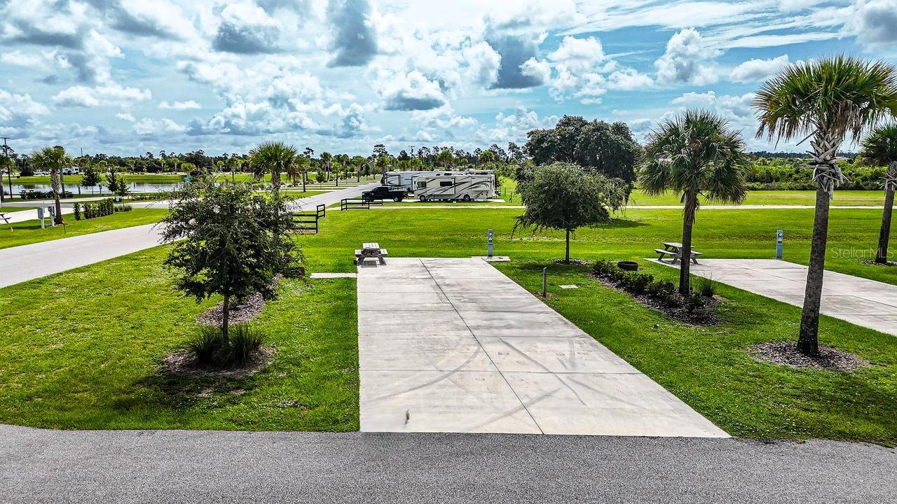 Rare opportunity to own in Resort at Canopy Oaks — one of Central Florida’s premier luxury RV resorts. Lot 241 offers an ideal location along the scenic nature trail and is positioned on a desirable corner lot, providing both accessibility and added privacy. Enjoy easy access to the dog park, Picnic Island, bathhouse, and laundry facilities — perfectly blending convenience with tranquil surroundings.

The spacious 20’ x 70’ concrete pad with full 20/30/50 amp hookups easily accommodates Class A and Class C motorhomes, fifth wheels, travel trailers, or even a small park model — making it ideal for seasonal enjoyment or extended stays.

Ownership includes access to 435 acres of gated resort amenities, including a tropical tiki bar with live music, resort-style pool and spa, pickleball courts, putting green, fitness center, and beautifully maintained grounds designed for elevated resort living.

Enjoy as a personal retreat or participate in the professionally managed rental program for potential income when you’re away. Developer incentives are currently available, adding even greater value to this exceptional opportunity.

Secure your place in this sought-after resort community before it’s gone.